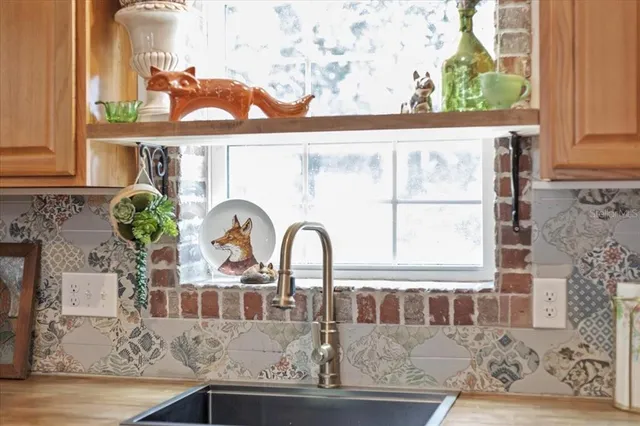 a bed sitting with a blanket and pillows