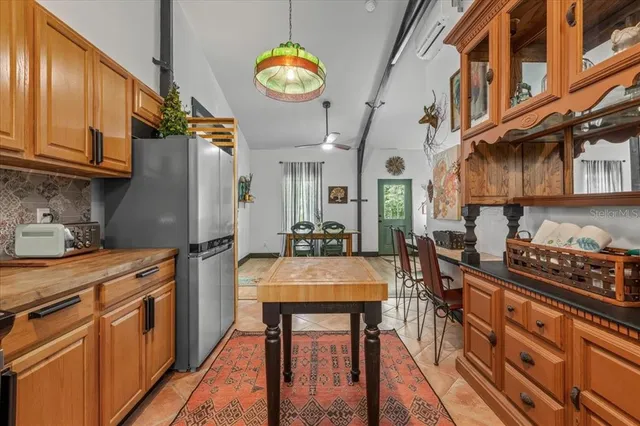 a bedroom with a bed and dresser with wooden floor