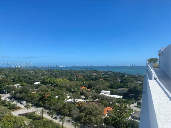 a view of a city with lush green forest
