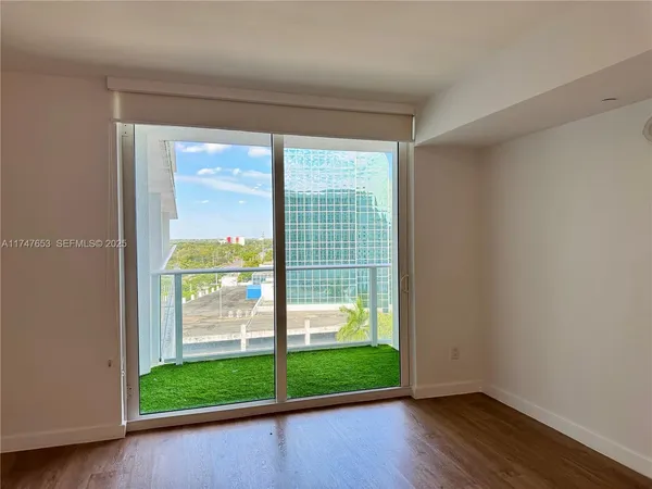 a small space with wooden floor and a window