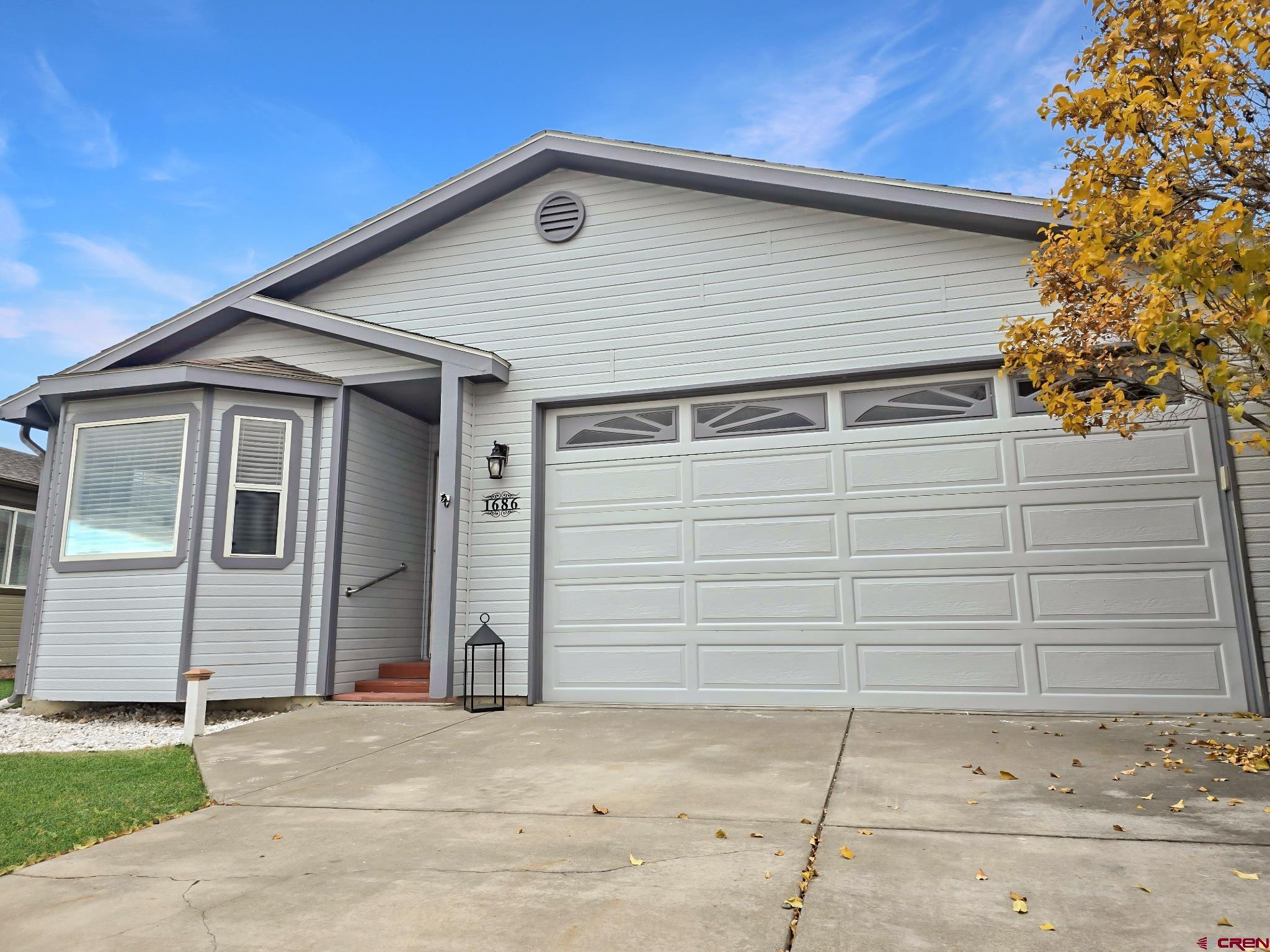 1686 Rheims Court Montrose, CO 81401 - Photo 1 of 18 a front view of a house