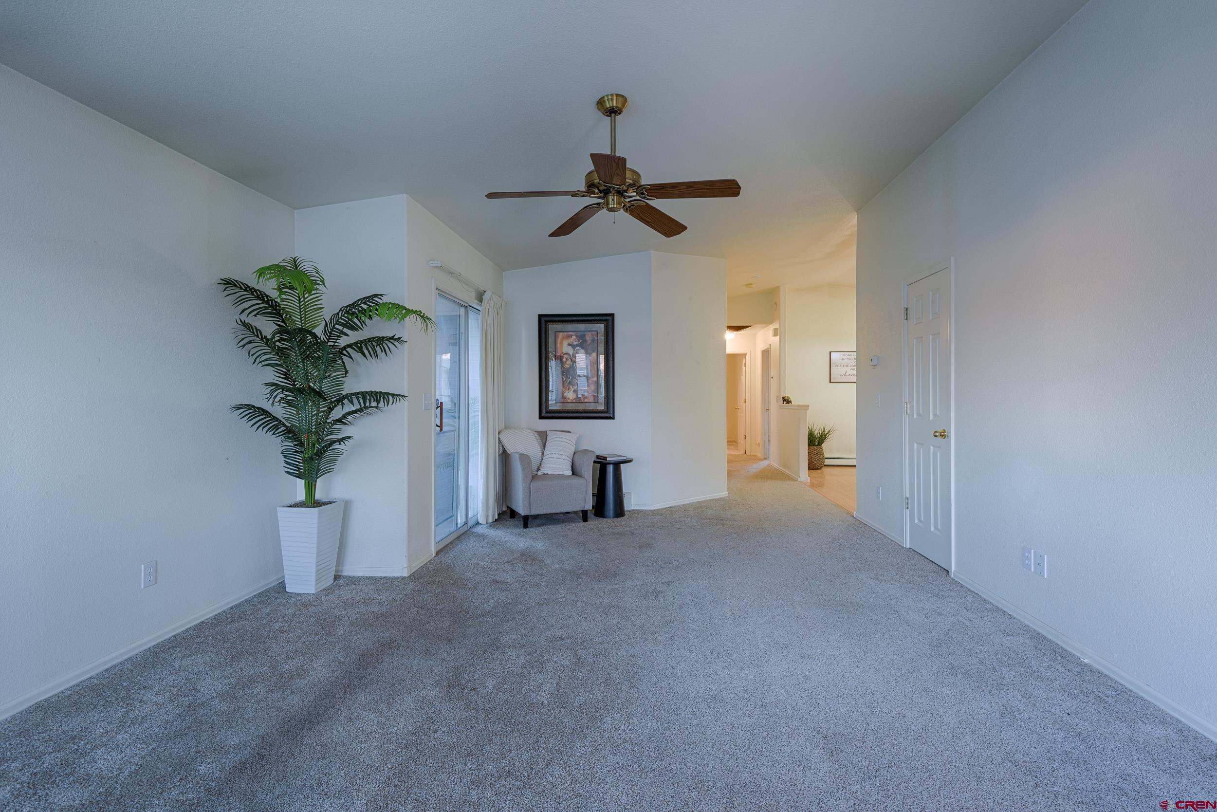 1686 Rheims Court Montrose, CO 81401 - Photo 2 of 18 a view of a livingroom with a potted plant