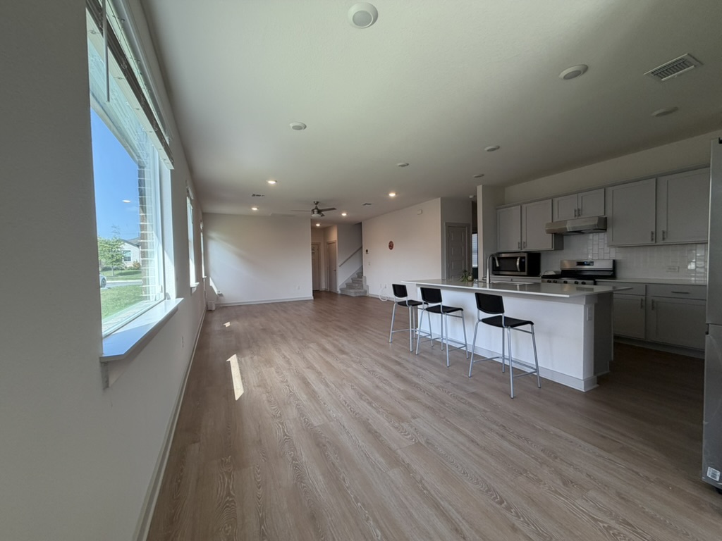 10708 Gonzales Ranger Pass Austin, TX 78754 - Photo 19 of 40 An open-concept layout unites the kitchen and living spaces, illuminated by generous natural light.