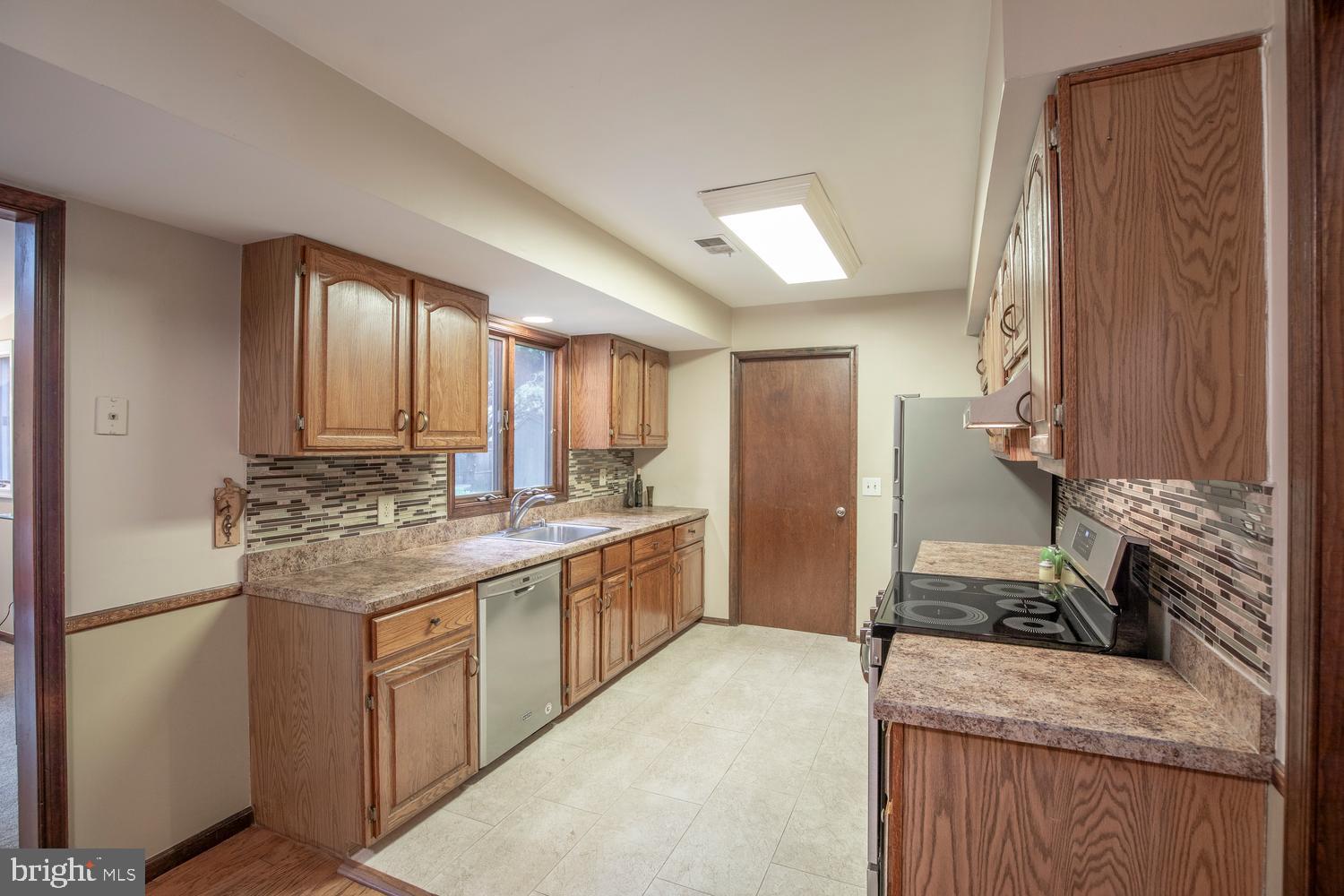 225 Pueblo Road Doylestown, PA 18901 - Photo 11 of 35 a kitchen with stainless steel appliances granite countertop a stove a sink and a refrigerator