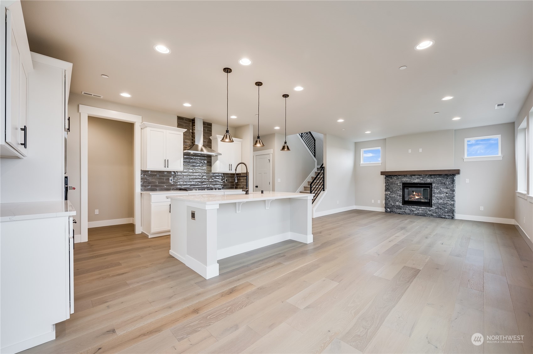 4321 243rd Place Southeast, Unit LOT31 Bothell, WA 98021 - Photo 14 of 35 a large kitchen with stainless steel appliances kitchen island a large counter top and a wooden floors