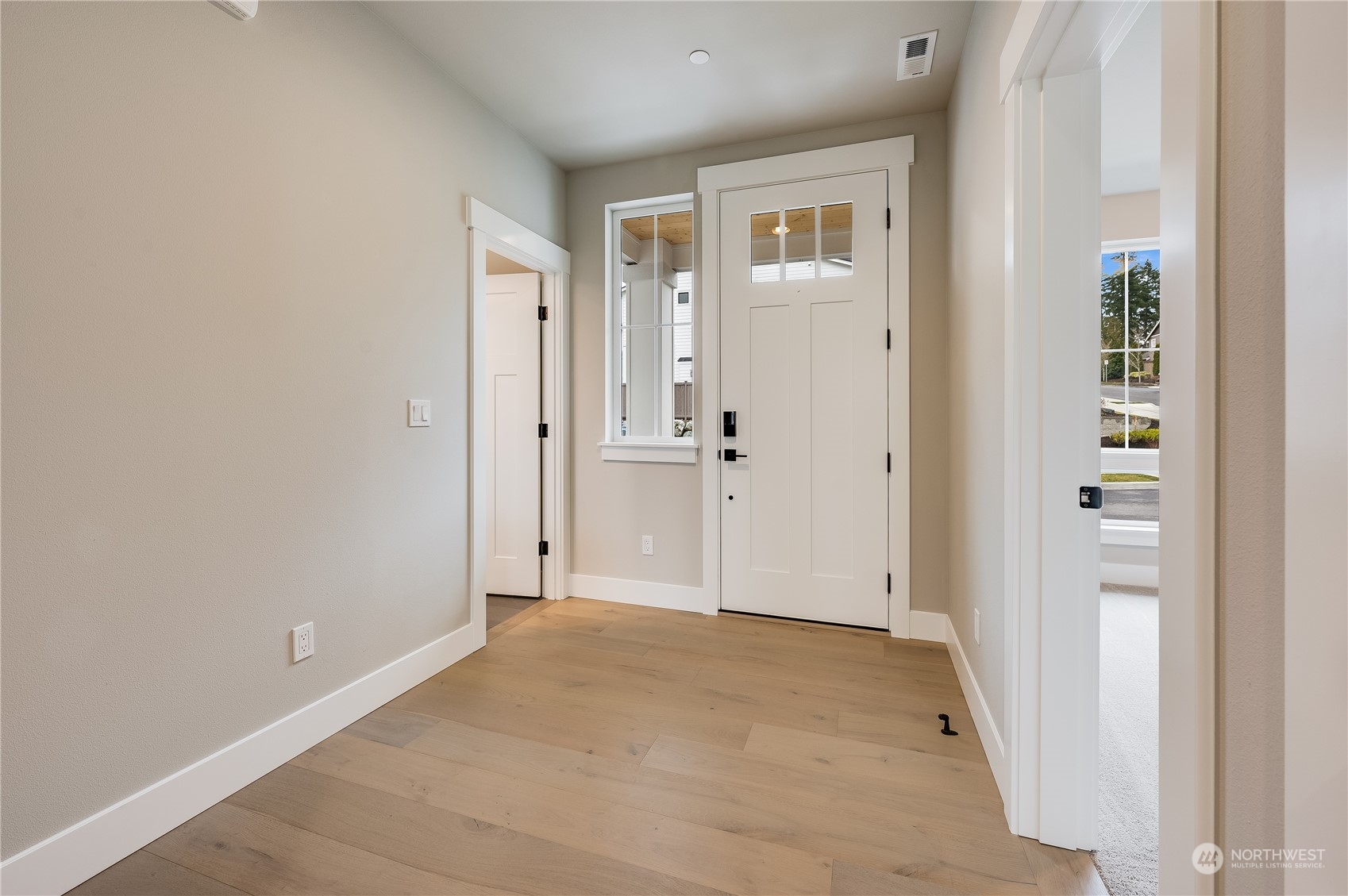 4321 243rd Place Southeast, Unit LOT31 Bothell, WA 98021 - Photo 4 of 35 an empty room with windows and entrance