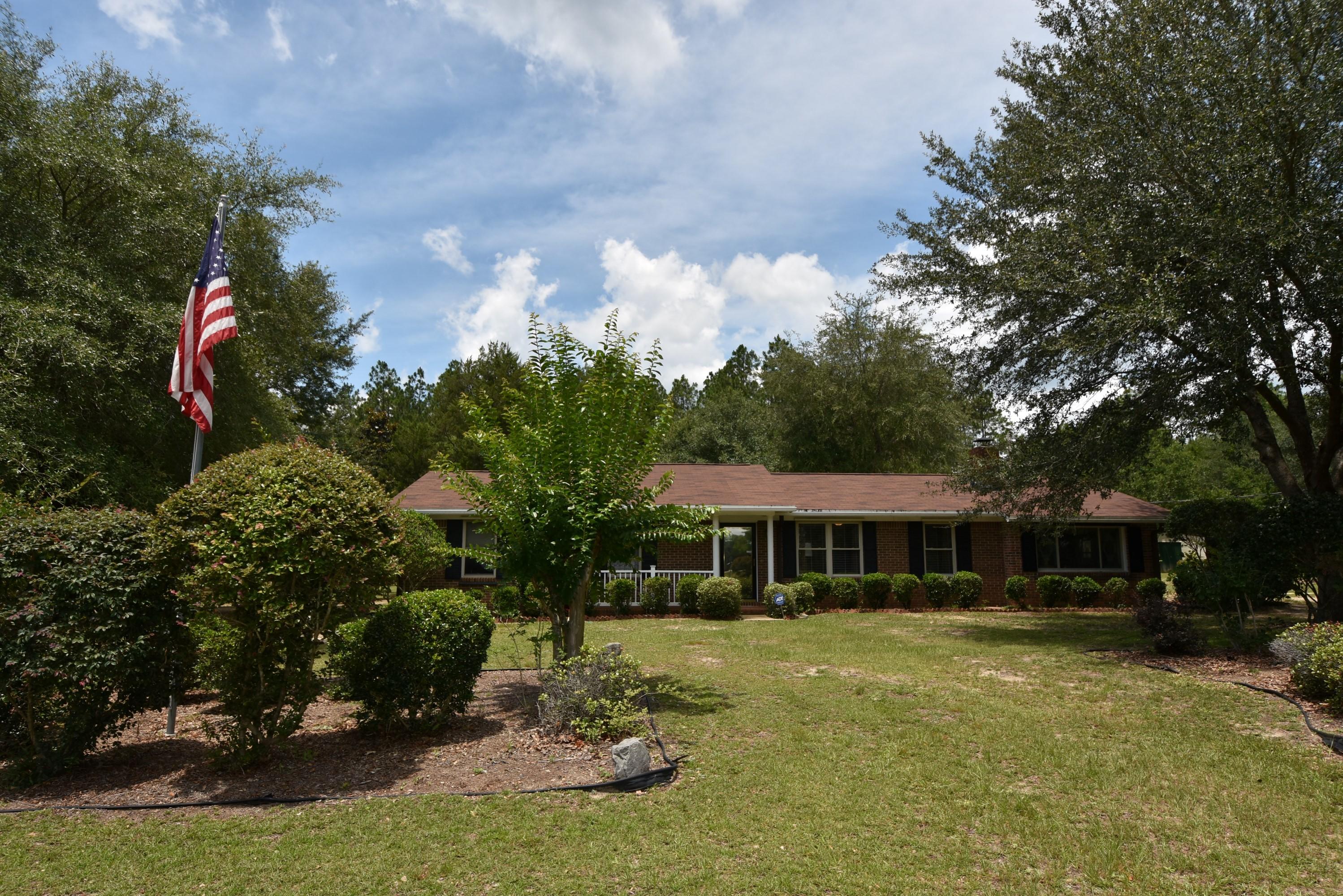 6008 Old Hickory Road Crestview, FL 32539 - Photo 1 of 57 a front view of a house with a yard table and chairs