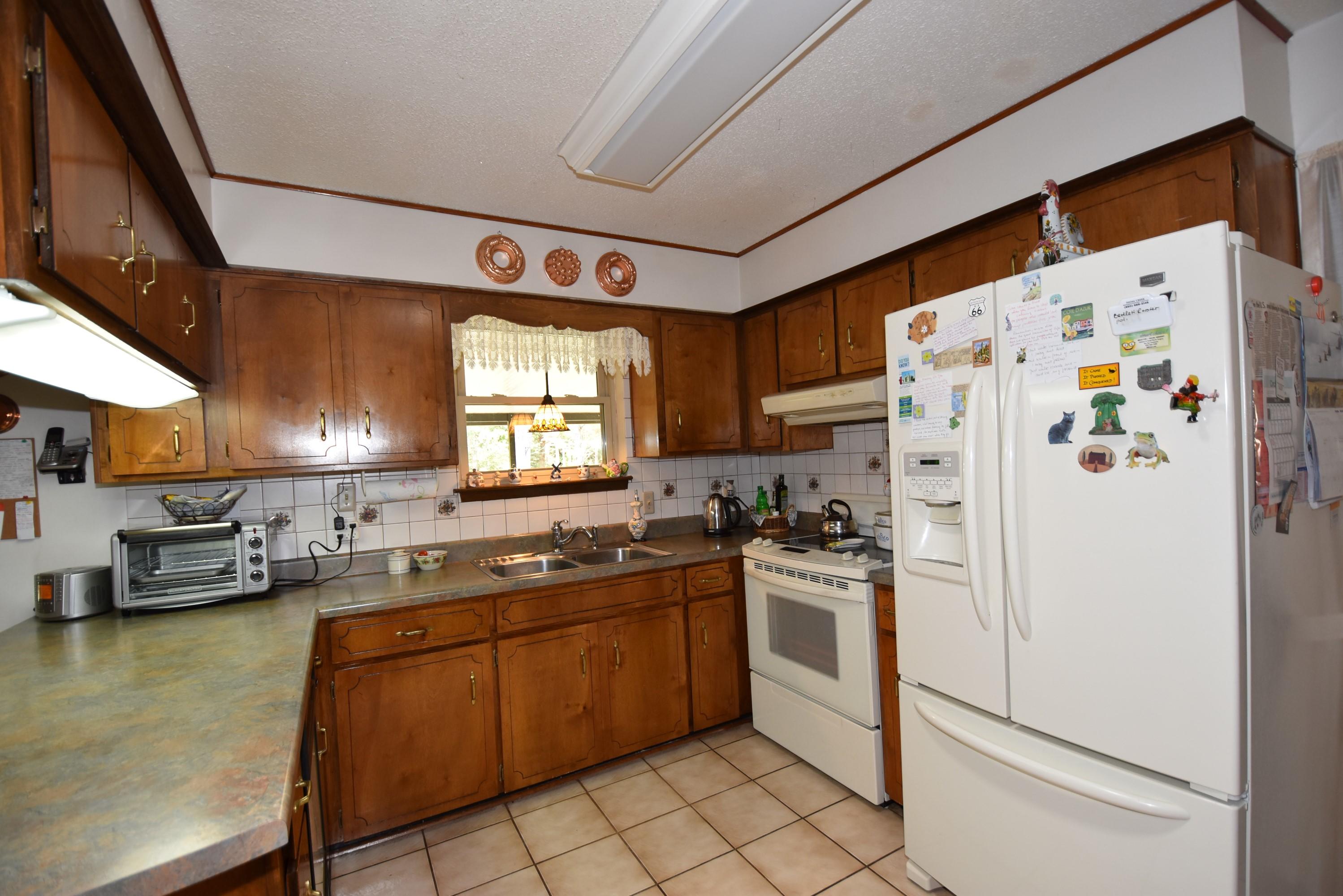 6008 Old Hickory Road Crestview, FL 32539 - Photo 12 of 57 a kitchen with stainless steel appliances granite countertop a refrigerator a sink a stove and a refrigerator