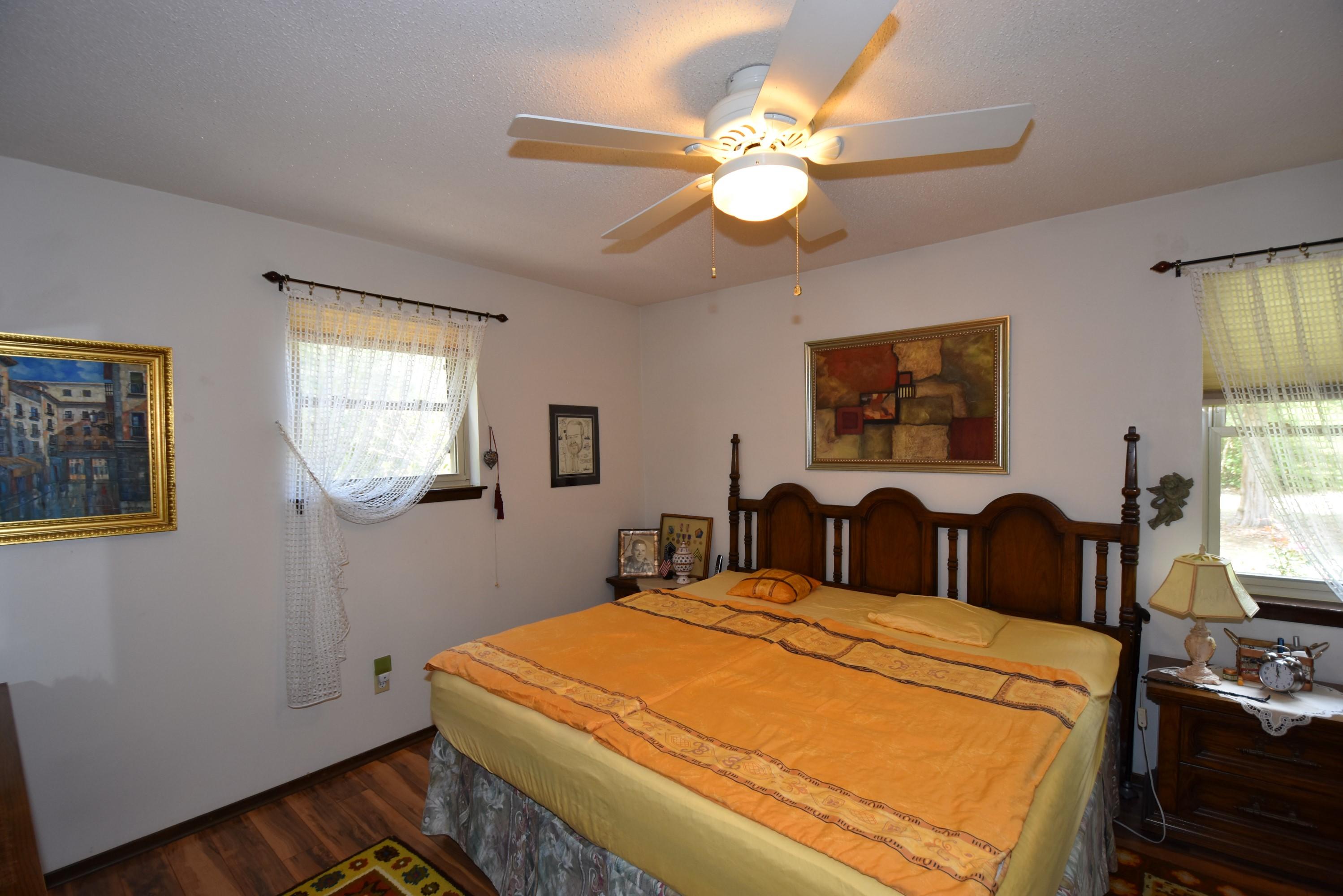 6008 Old Hickory Road Crestview, FL 32539 - Photo 19 of 57 a bedroom with a bed and a chandelier
