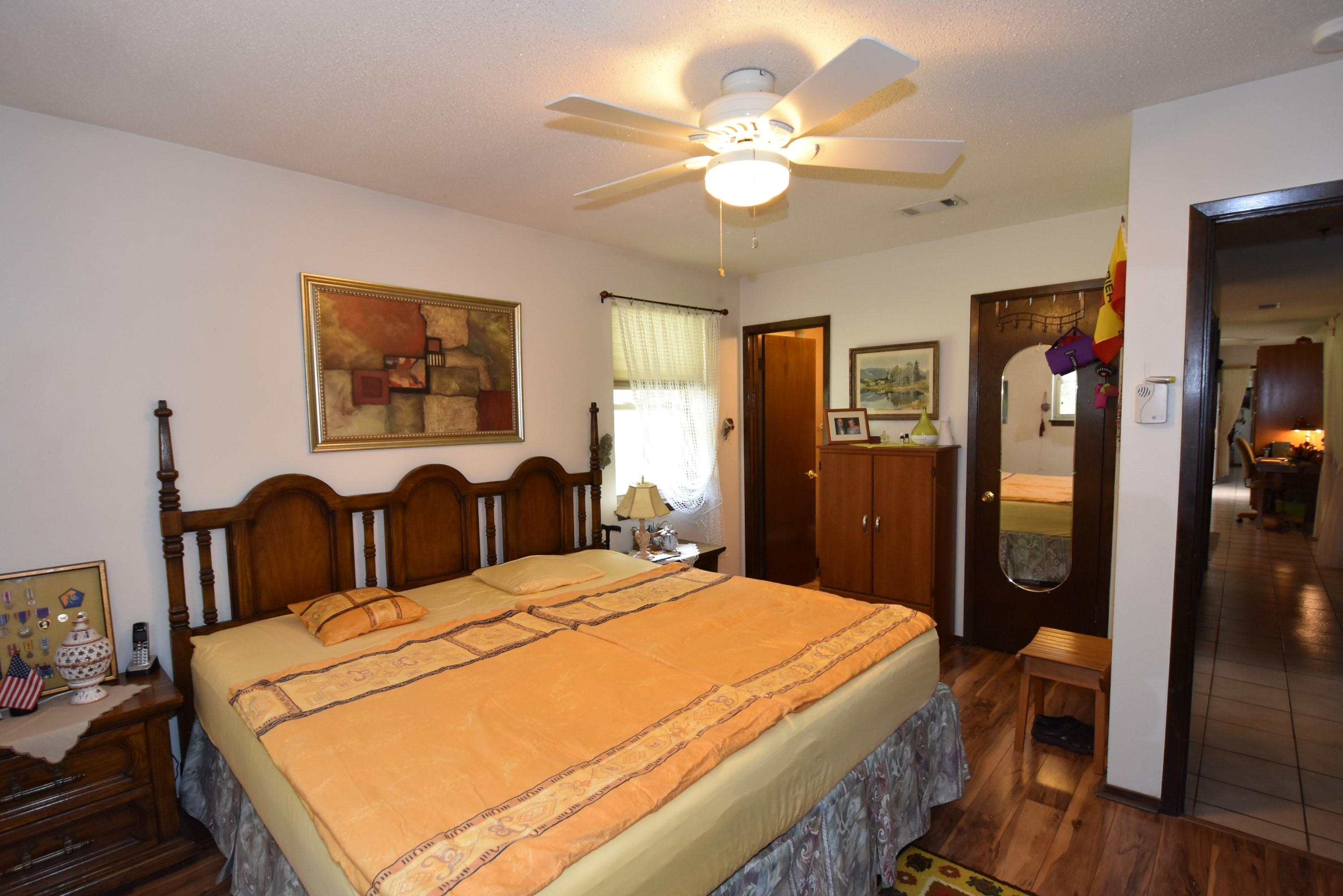 6008 Old Hickory Road Crestview, FL 32539 - Photo 21 of 57 a spacious bedroom with a bed a dresser and potted plant
