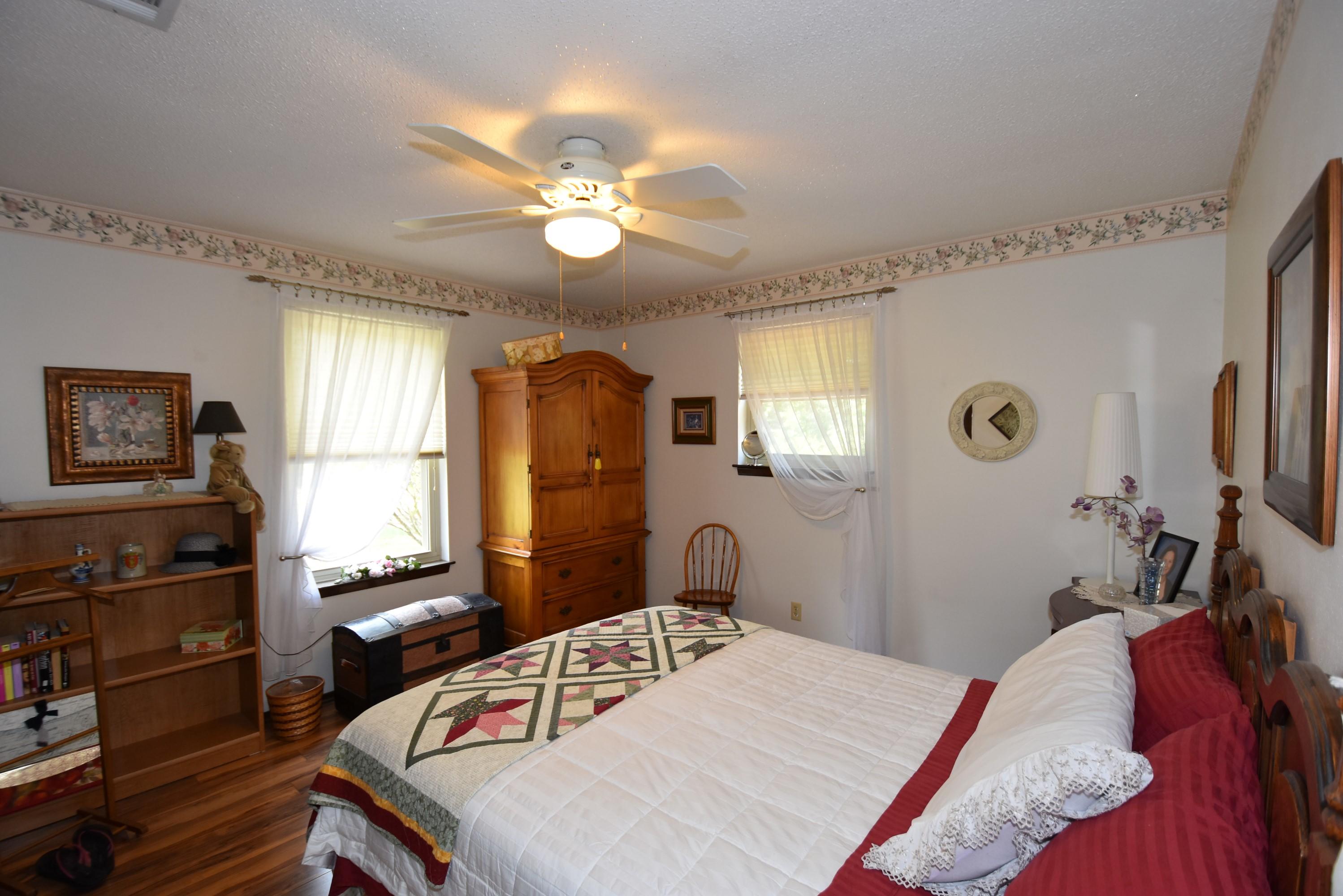 6008 Old Hickory Road Crestview, FL 32539 - Photo 24 of 57 a bedroom with a bed and a chandelier