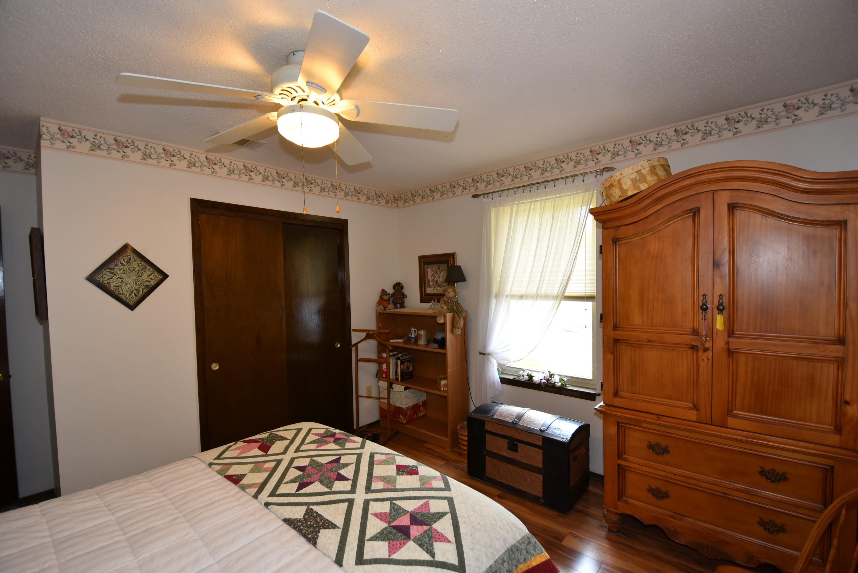 6008 Old Hickory Road Crestview, FL 32539 - Photo 25 of 57 a bedroom with a bed and a chandelier