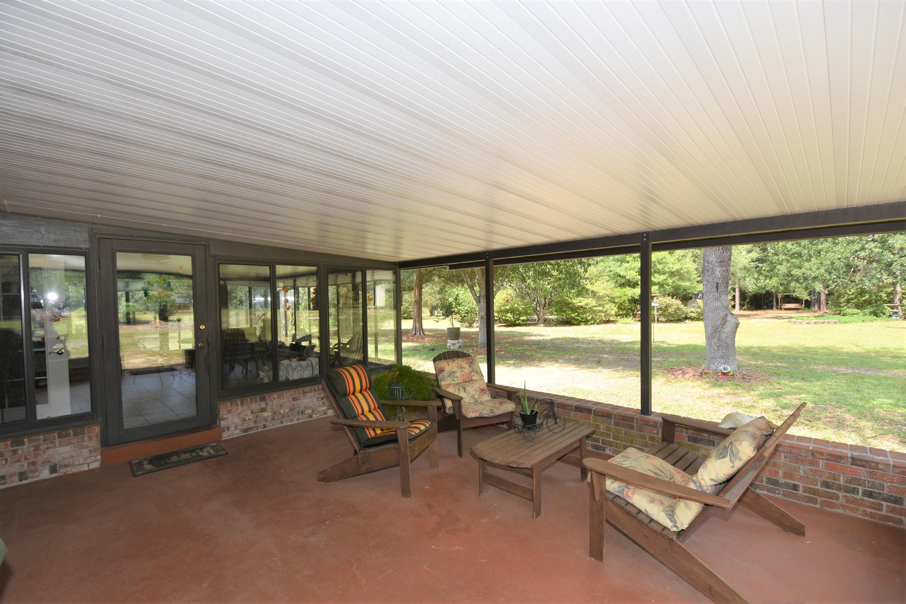 6008 Old Hickory Road Crestview, FL 32539 - Photo 28 of 57 a living room with furniture and floor to ceiling windows