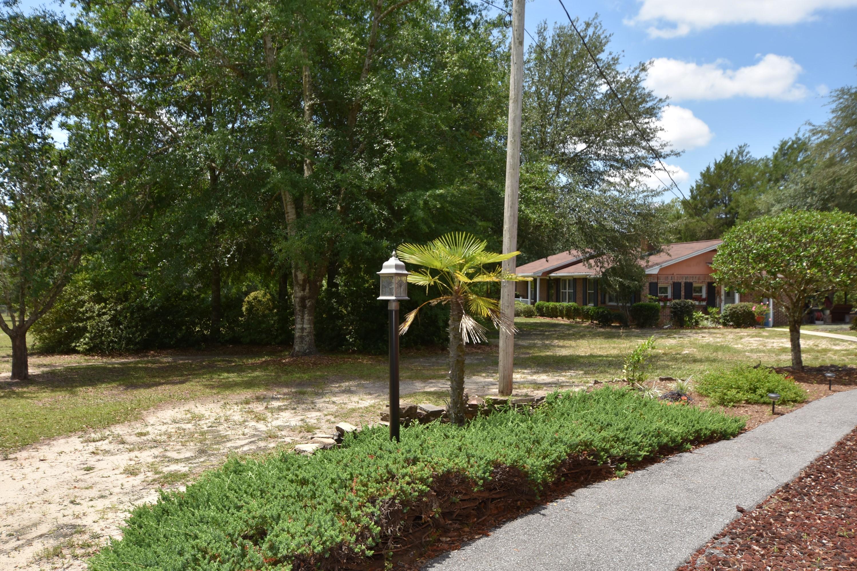 6008 Old Hickory Road Crestview, FL 32539 - Photo 51 of 57 a view of a garden with a bench