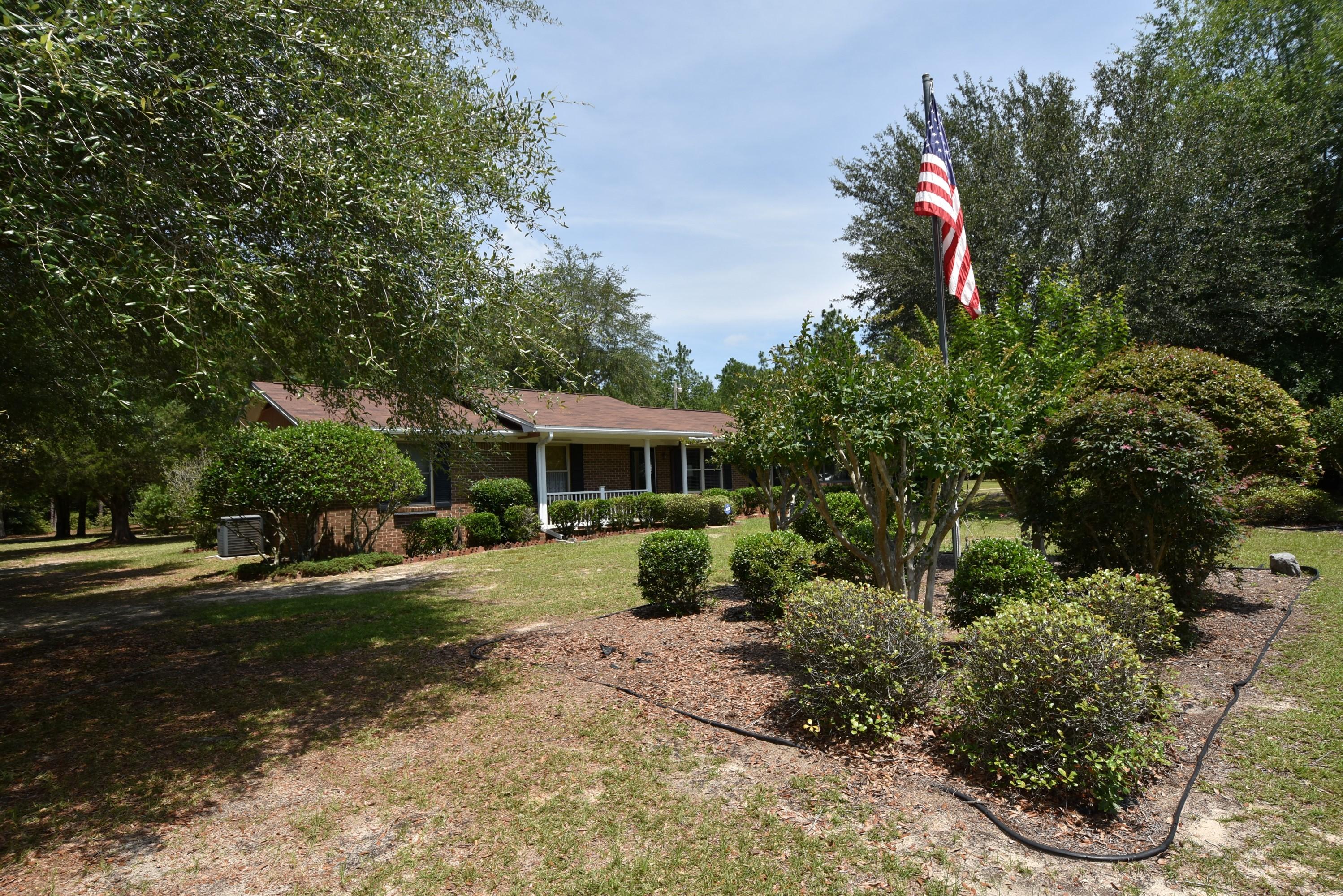 6008 Old Hickory Road Crestview, FL 32539 - Photo 54 of 57 a front view of a house with a yard and shrubs