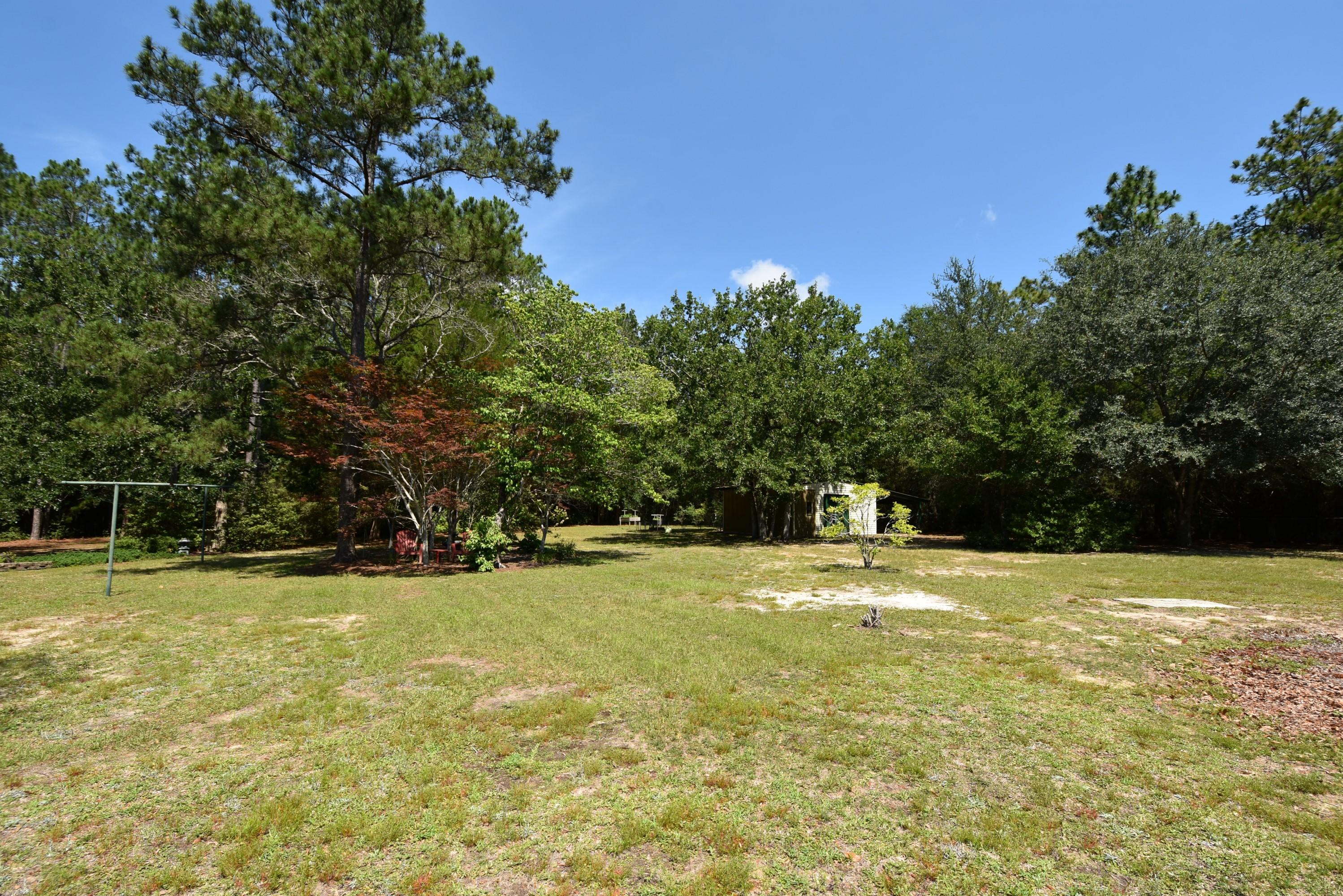 6008 Old Hickory Road Crestview, FL 32539 - Photo 56 of 57 a view of a swimming pool with an outdoor space and seating area