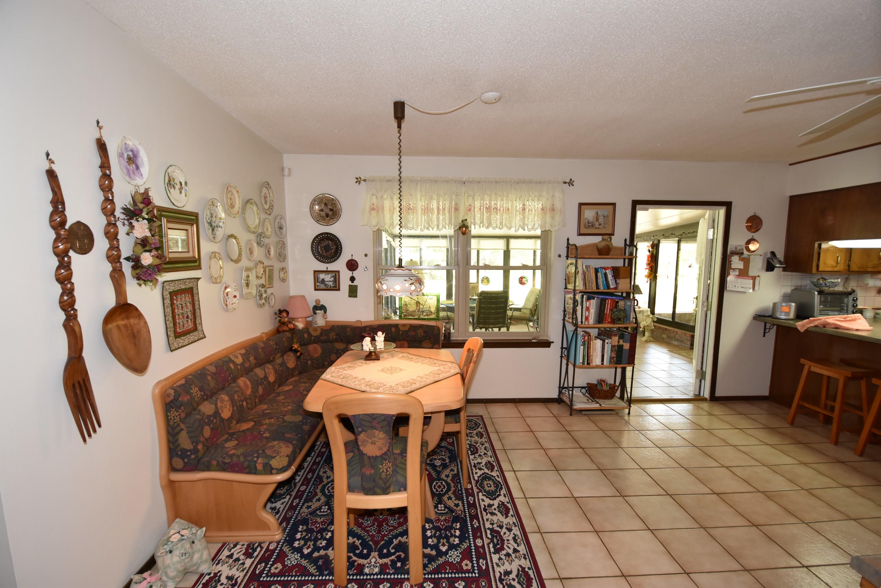 6008 Old Hickory Road Crestview, FL 32539 - Photo 7 of 57 a living room with furniture a dining table and a fireplace