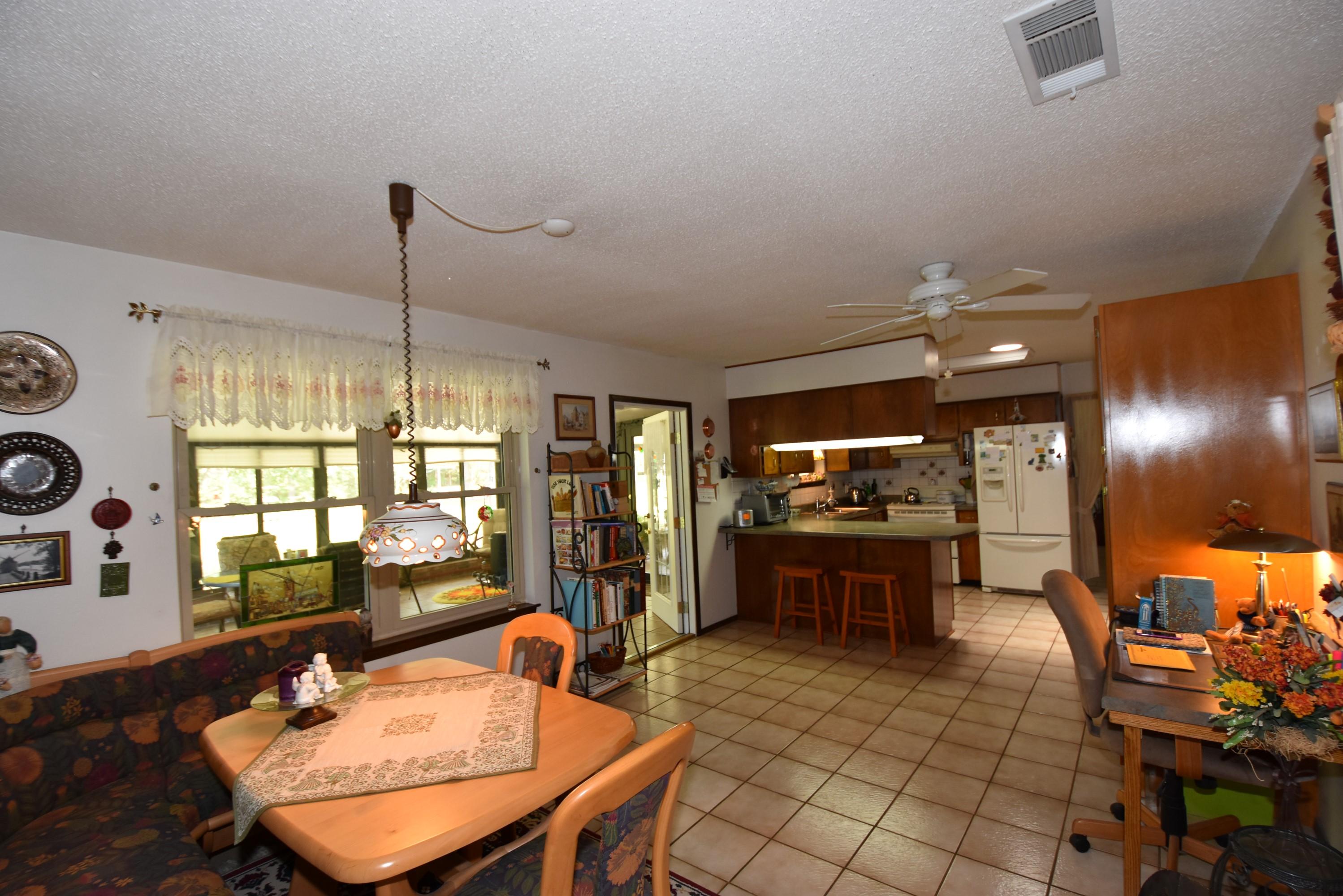 6008 Old Hickory Road Crestview, FL 32539 - Photo 8 of 57 a dining room with furniture a chandelier and window