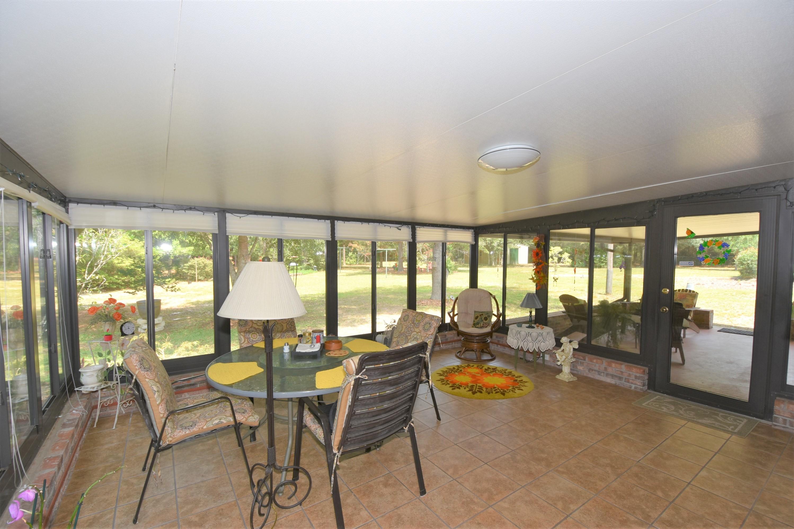 6008 Old Hickory Road Crestview, FL 32539 - Photo 9 of 57 a view of a dining room with furniture water view and large windows