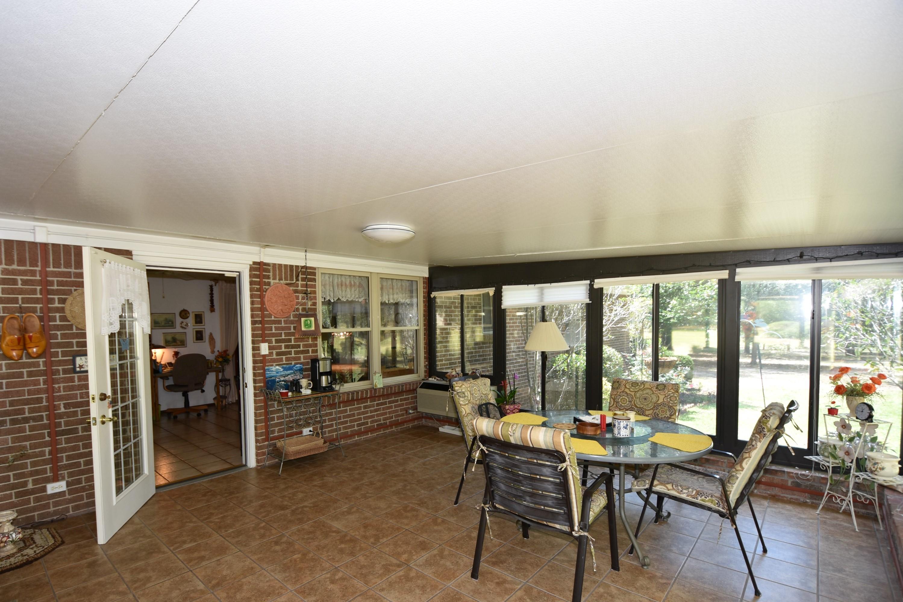6008 Old Hickory Road Crestview, FL 32539 - Photo 10 of 57 a dining room with furniture and wooden floor