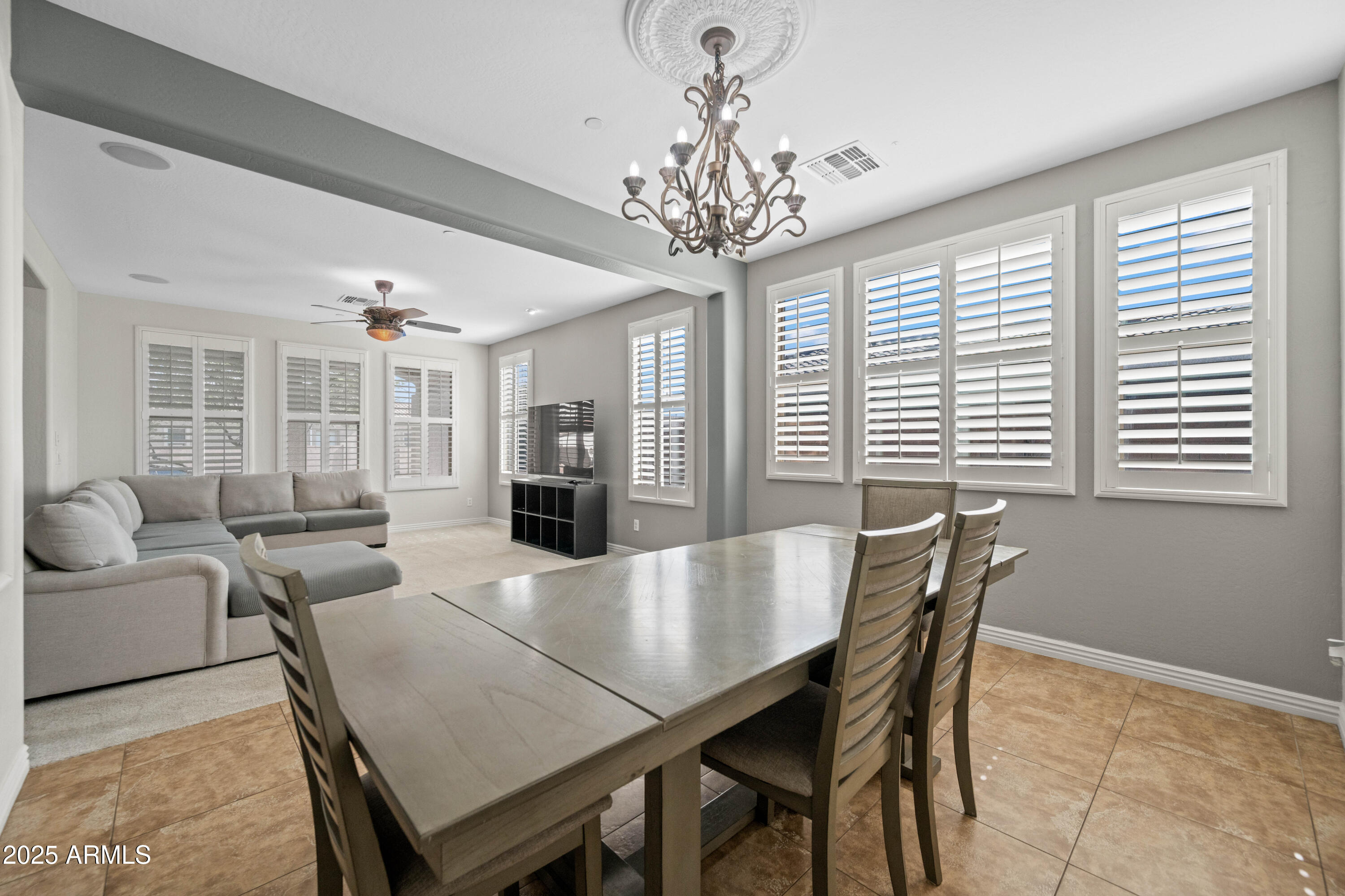 16880 West Jackson Street Goodyear, AZ 85338 - Photo 15 of 86 a view of a dining room with furniture and a chandelier