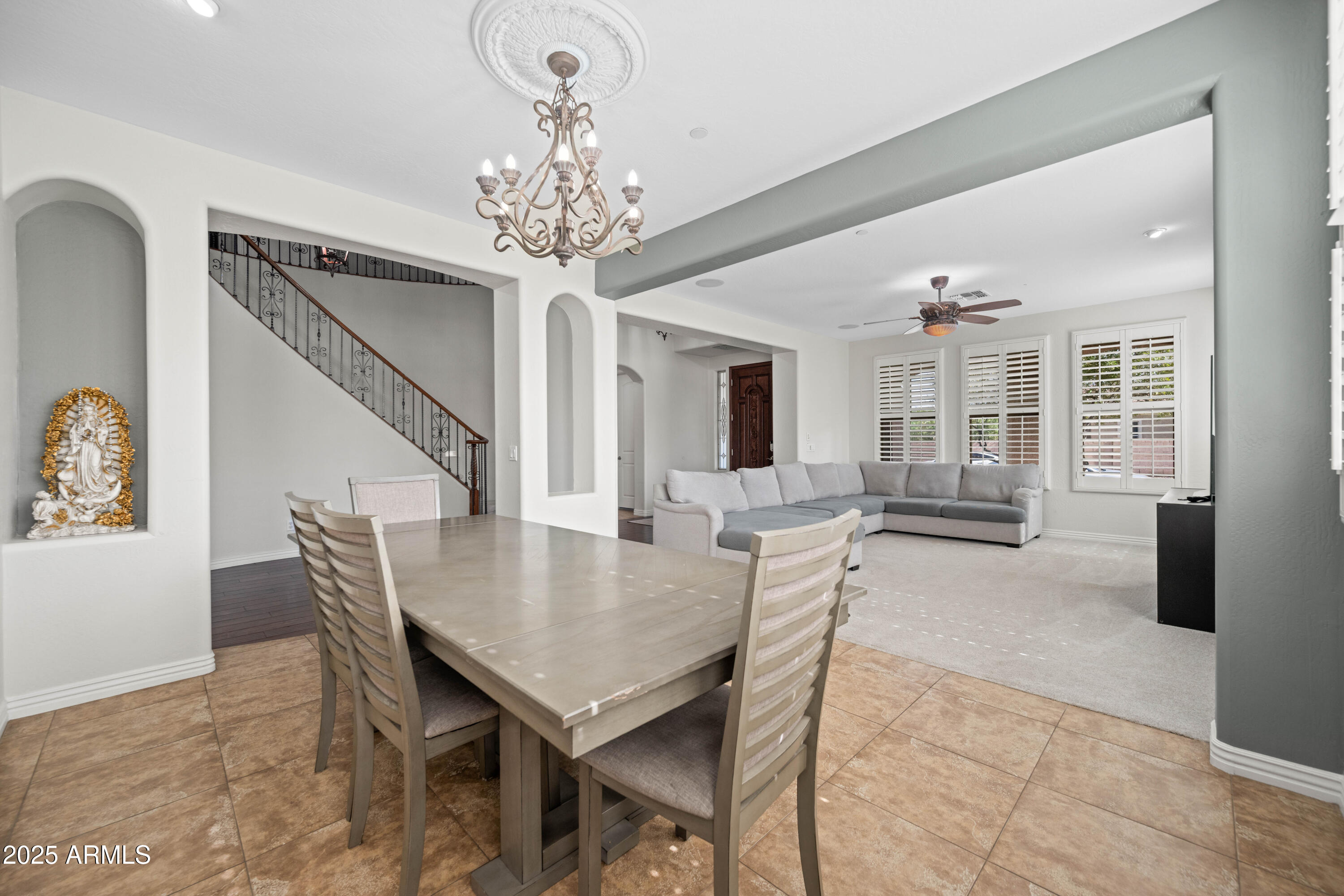 16880 West Jackson Street Goodyear, AZ 85338 - Photo 16 of 86 a view of a dining room with furniture and chandelier