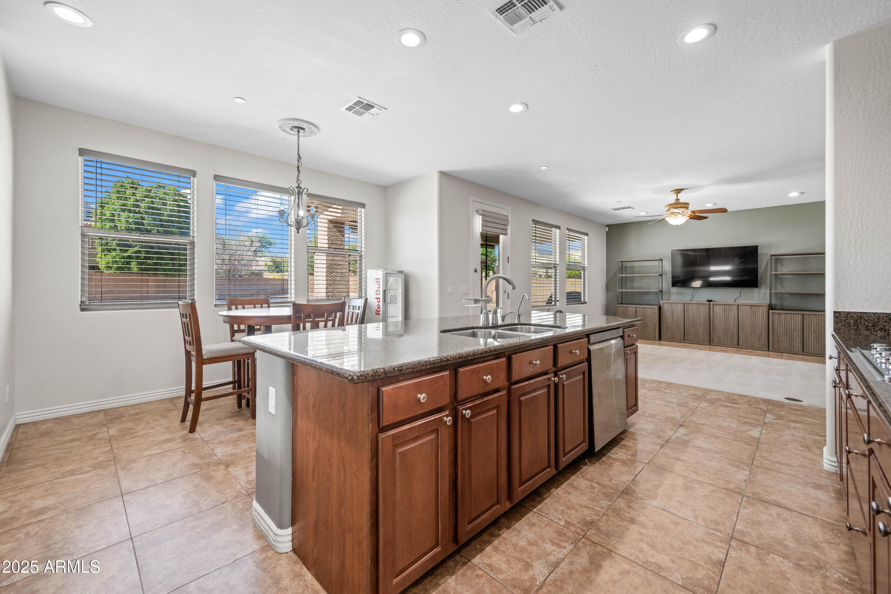 16880 West Jackson Street Goodyear, AZ 85338 - Photo 25 of 86 a large kitchen with kitchen island granite countertop a large counter top and stainless steel appliances
