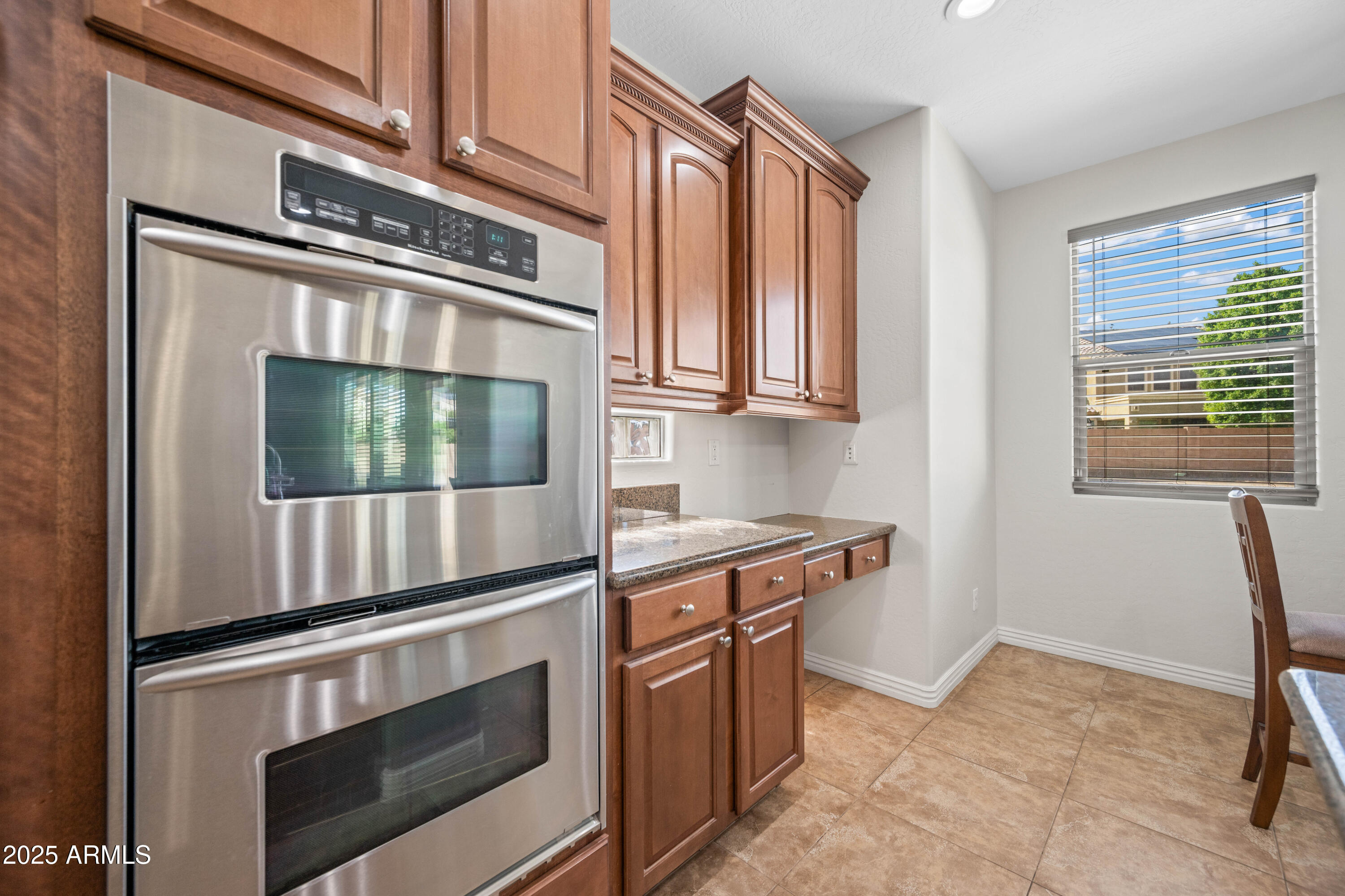 16880 West Jackson Street Goodyear, AZ 85338 - Photo 26 of 86 a kitchen with stainless steel appliances granite countertop a stove and a microwave