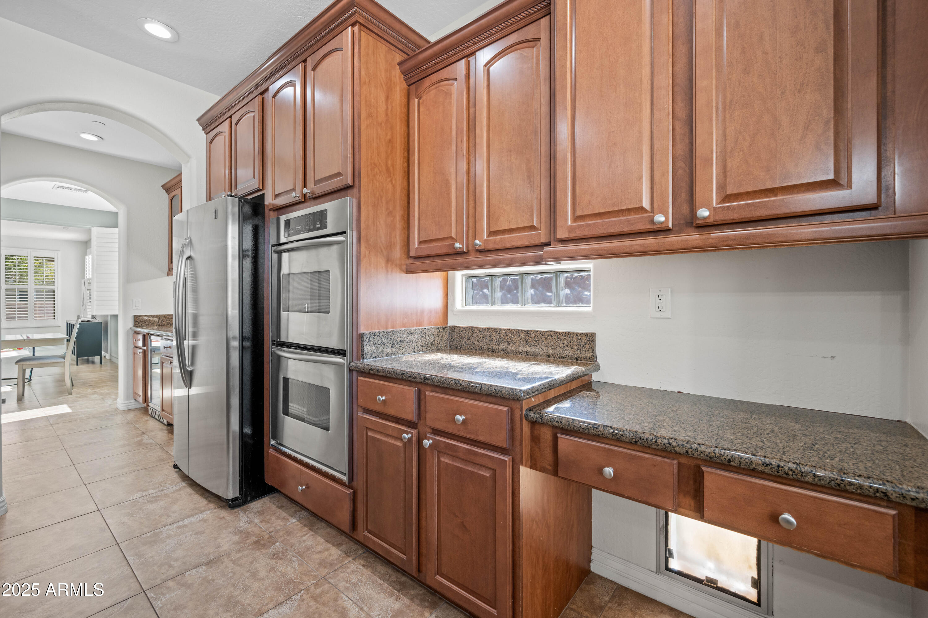 16880 West Jackson Street Goodyear, AZ 85338 - Photo 27 of 86 a kitchen with stainless steel appliances granite countertop a stove a refrigerator and a microwave