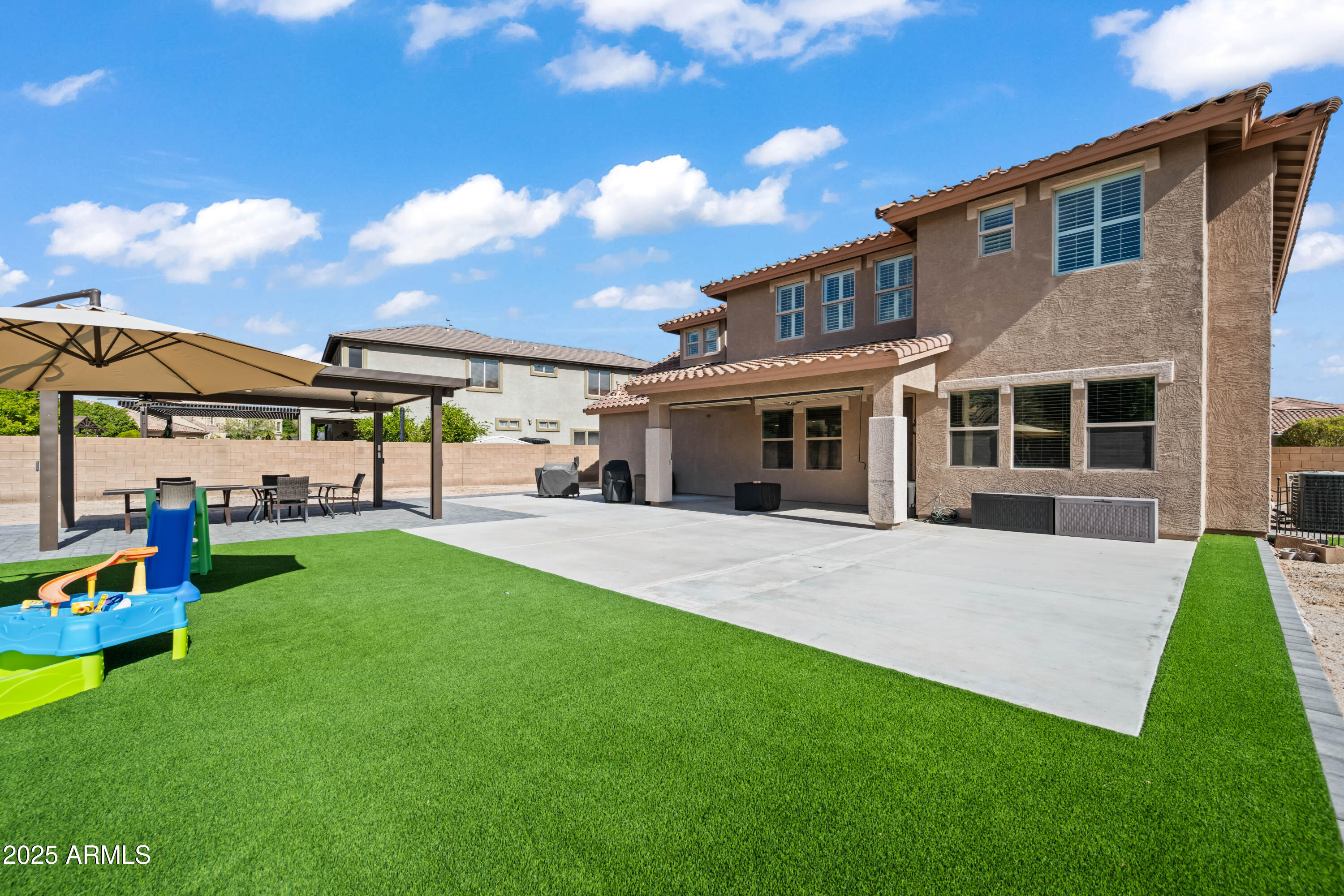 16880 West Jackson Street Goodyear, AZ 85338 - Photo 3 of 86 a view of an house with backyard and porch