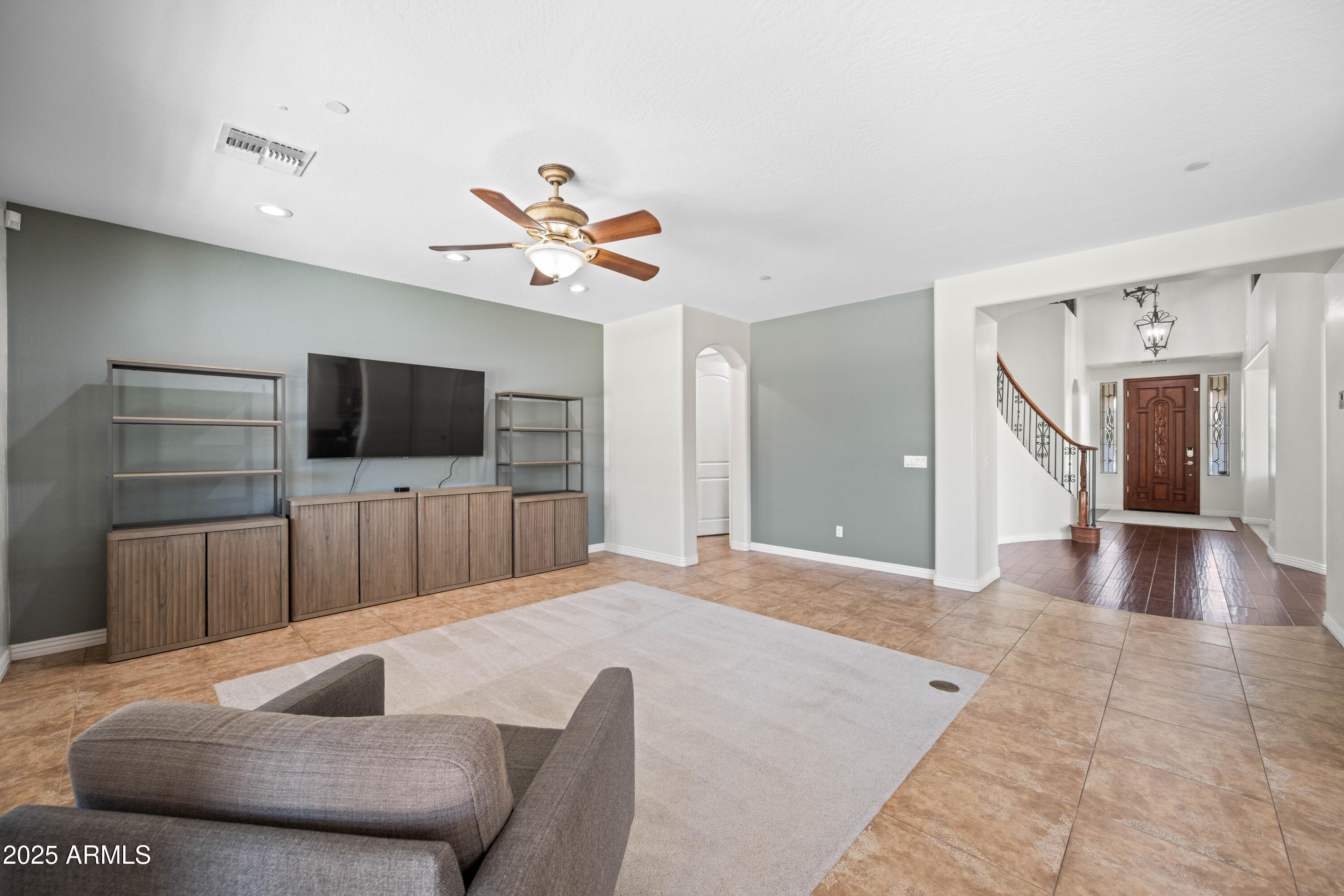16880 West Jackson Street Goodyear, AZ 85338 - Photo 32 of 86 a living room with furniture and a flat screen tv