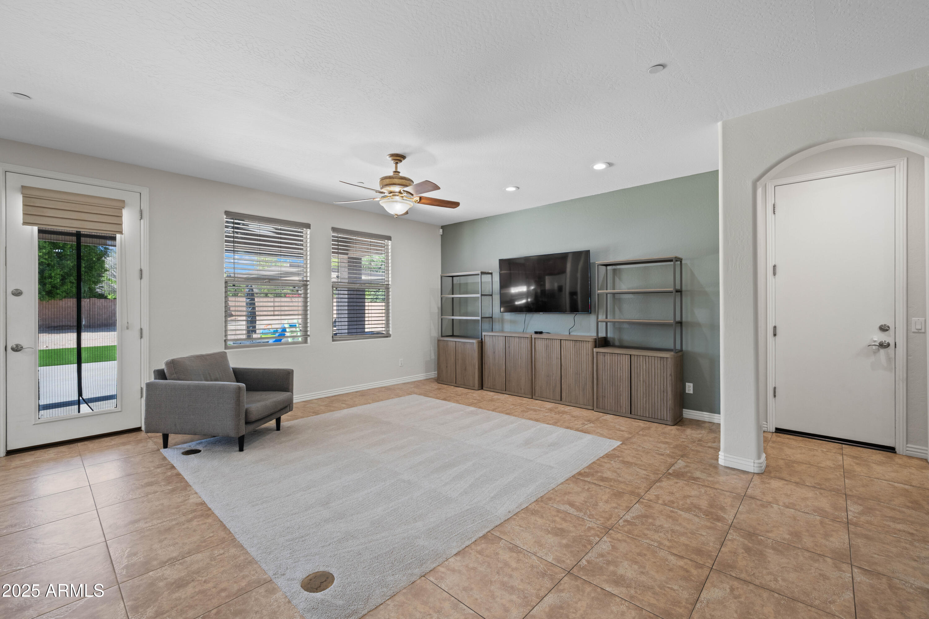16880 West Jackson Street Goodyear, AZ 85338 - Photo 34 of 86 a living room with furniture and a flat screen tv