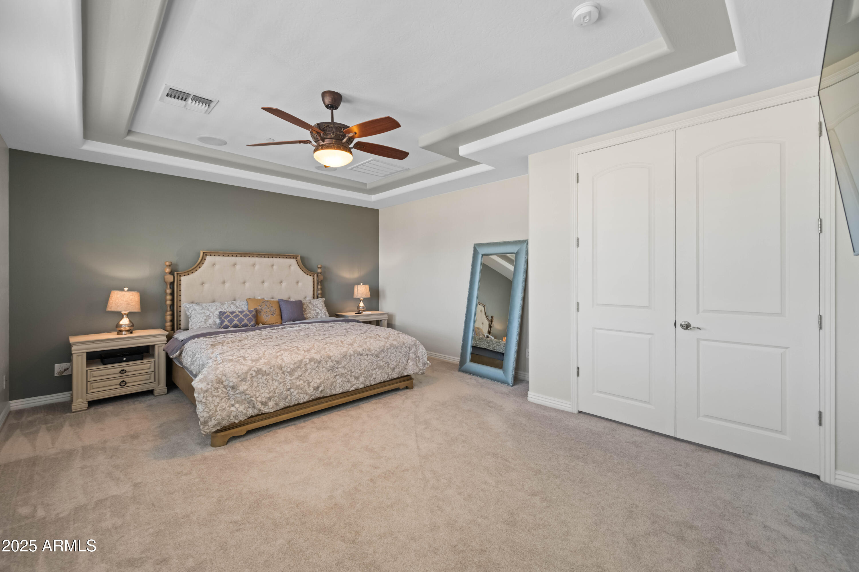 16880 West Jackson Street Goodyear, AZ 85338 - Photo 47 of 86 a bedroom with a bed and a chandelier