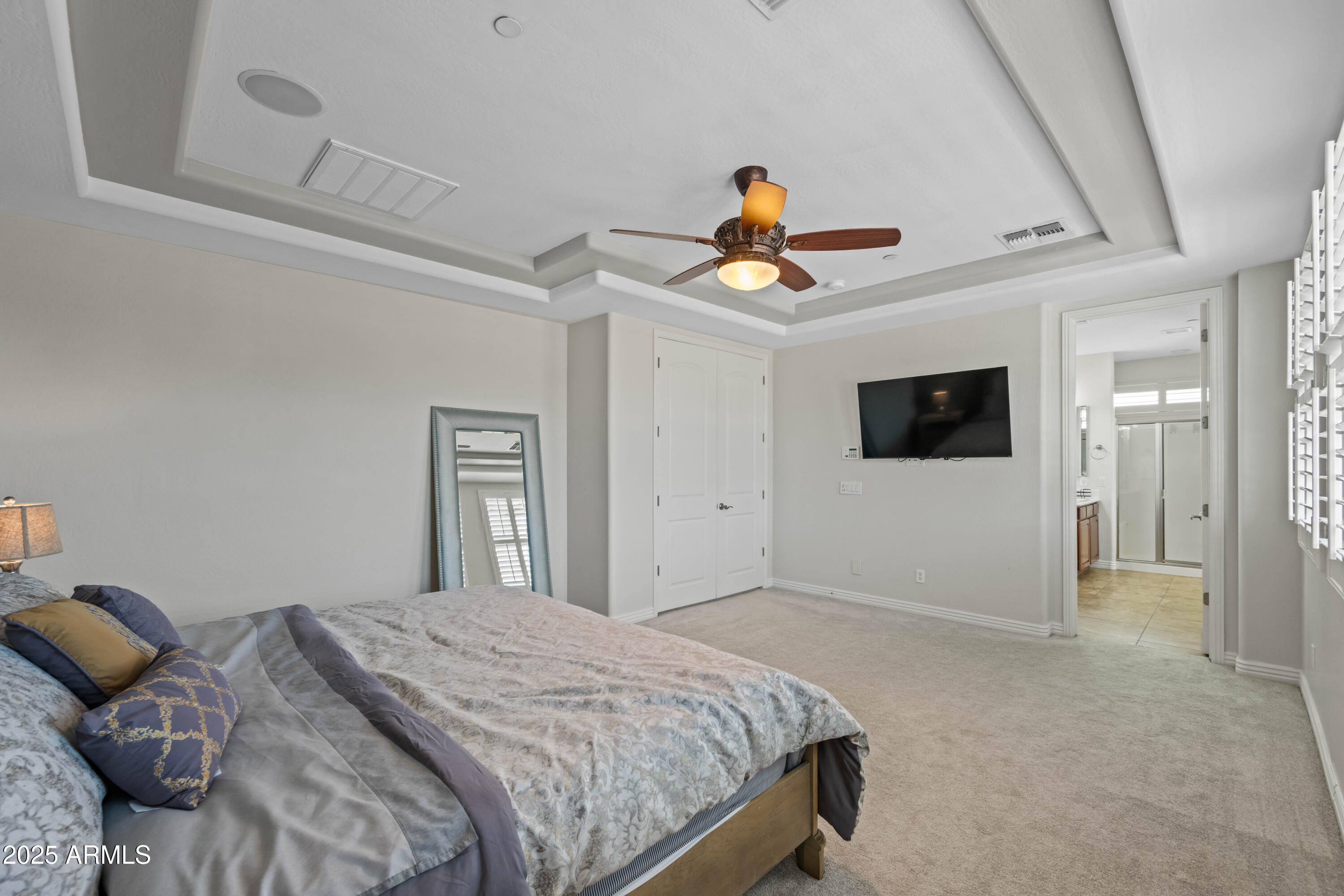 16880 West Jackson Street Goodyear, AZ 85338 - Photo 49 of 86 a bedroom with a bed a flat screen tv and view