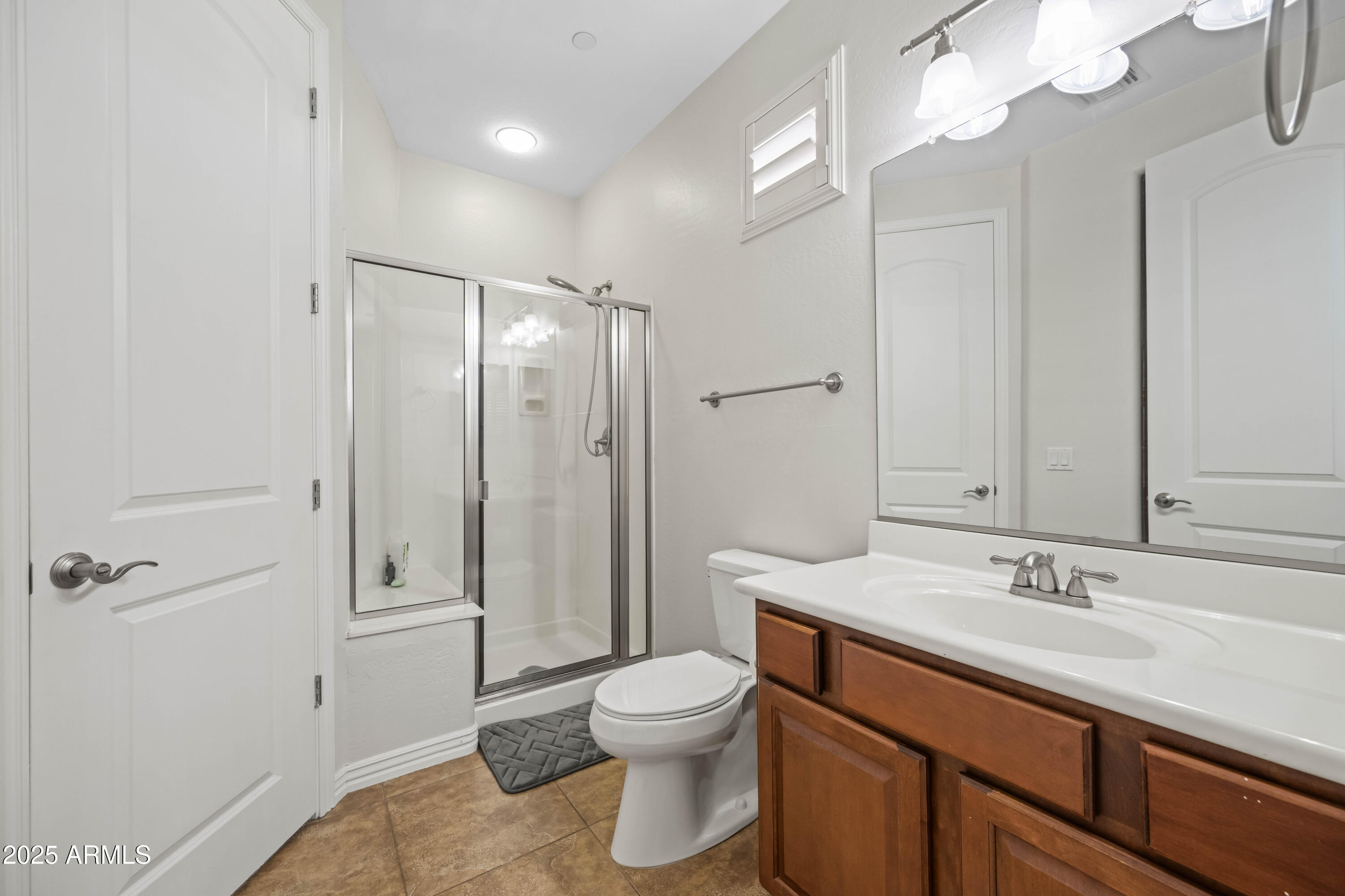 16880 West Jackson Street Goodyear, AZ 85338 - Photo 69 of 86 a bathroom with a toilet a sink and mirror