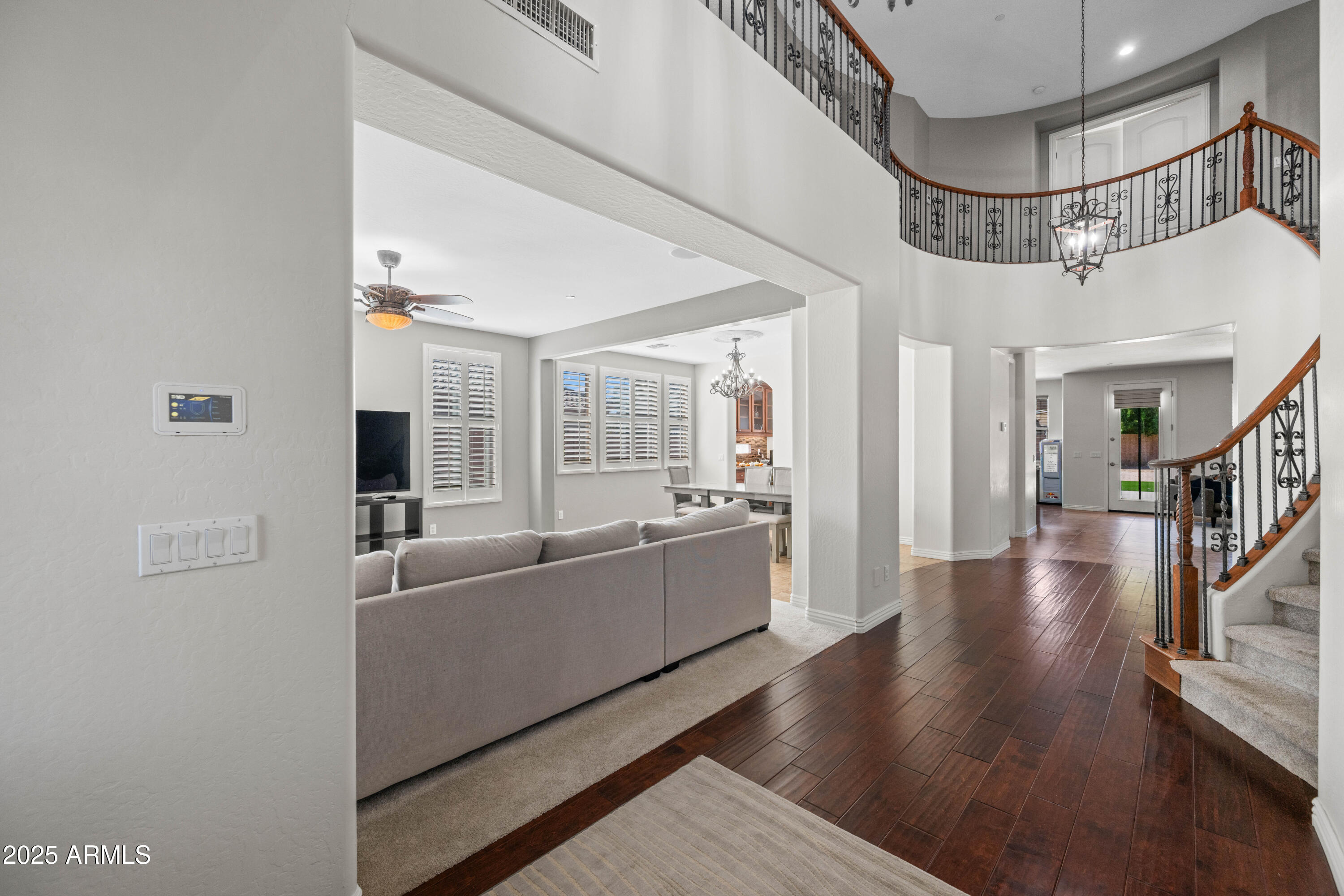 16880 West Jackson Street Goodyear, AZ 85338 - Photo 10 of 86 a living room with furniture and a chandelier