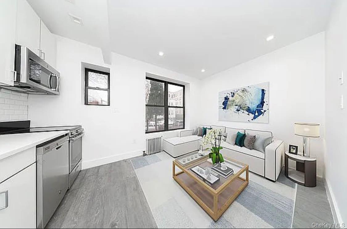 372 Rutland Road Brooklyn, NY 11225 - Photo 3 of 10 Living area featuring radiator, light wood finished floors, and recessed lighting
