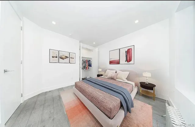 a bedroom with a bed and a painting on the wall