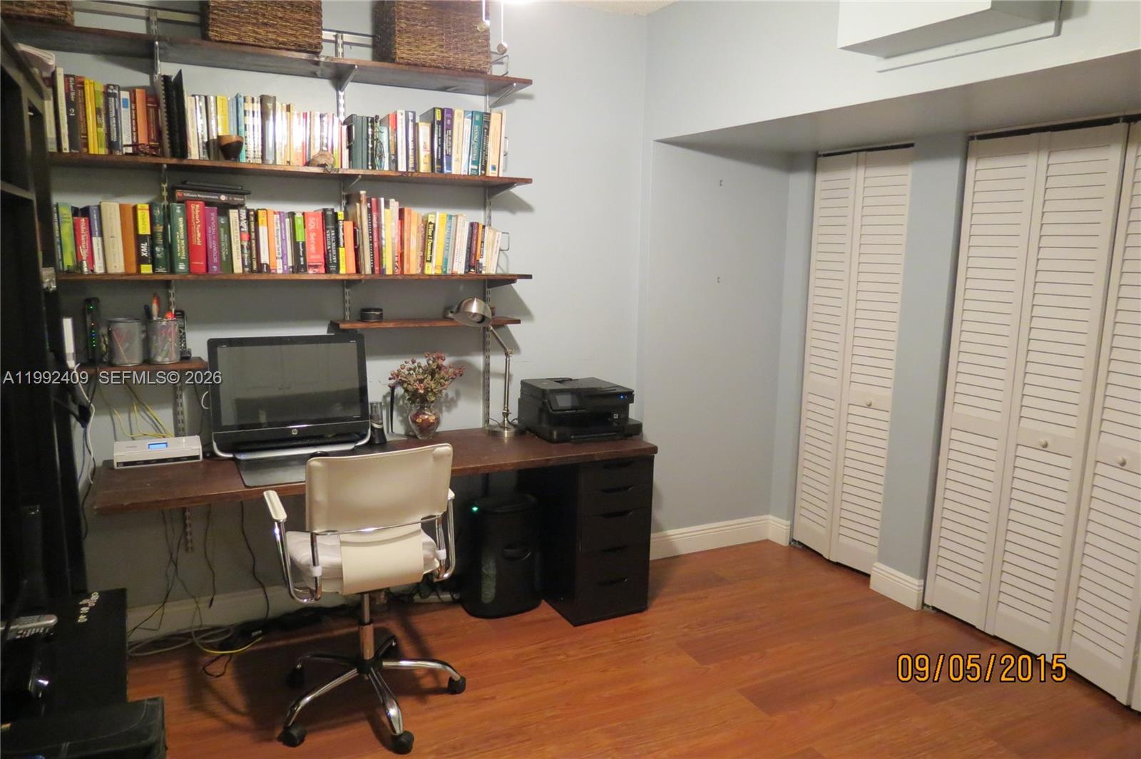 11841 Southwest 94th Street Miami, FL 33186 - Photo 11 of 19 a workspace with a bookshelf