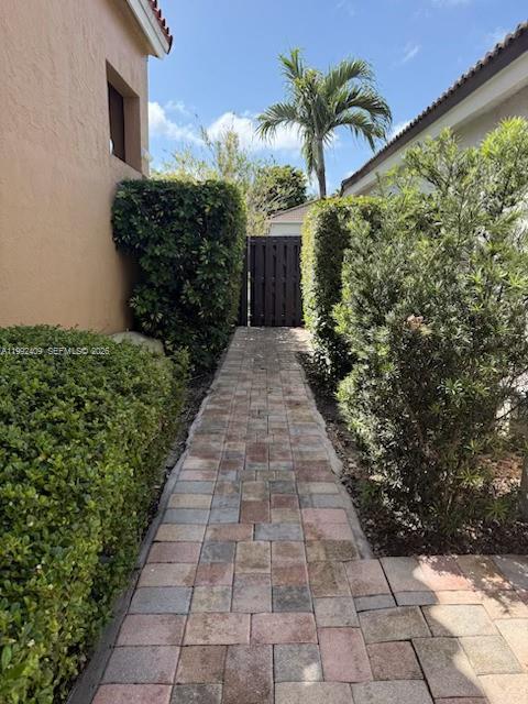 11841 Southwest 94th Street Miami, FL 33186 - Photo 18 of 19 a view of a pathway with flower plants