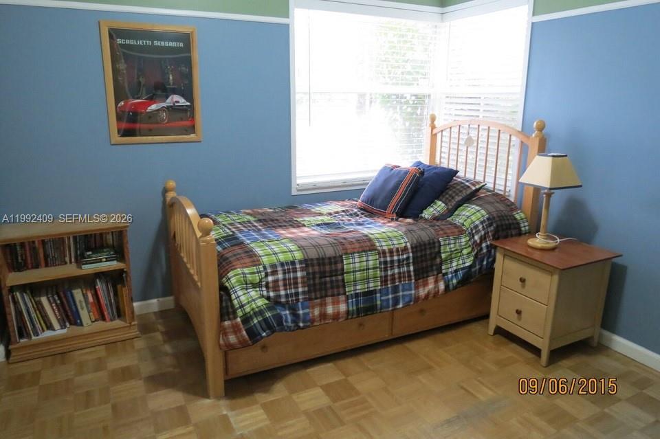 11841 Southwest 94th Street Miami, FL 33186 - Photo 9 of 19 a bedroom with a bed and the book shelf