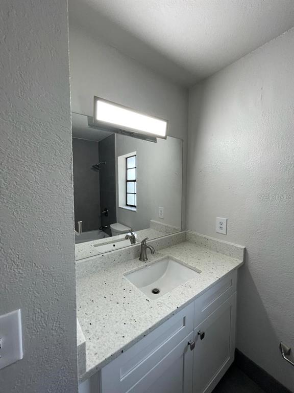 10260 Turkey Lake Road, Unit 150 (A30) Orlando, FL 32819 - Photo 10 of 13 a bathroom with a sink and a mirror