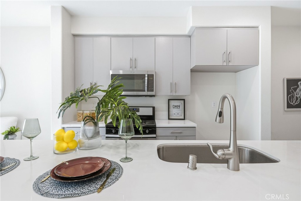 11130 Legion Loop, Unit 105 El Monte, CA 91731 - Photo 1 of 49 a bathroom with a granite countertop sink and a mirror