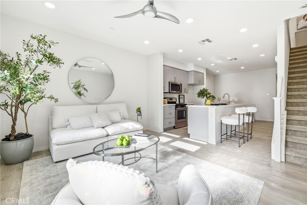 11130 Legion Loop, Unit 105 El Monte, CA 91731 - Photo 11 of 49 a living room with furniture and a large window