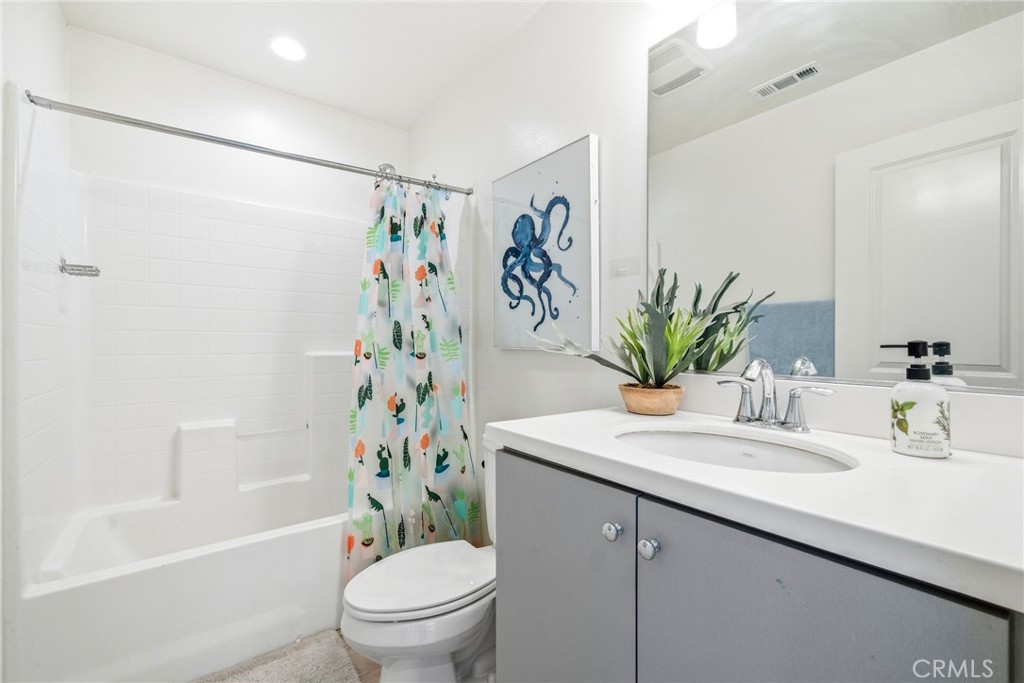 11130 Legion Loop, Unit 105 El Monte, CA 91731 - Photo 14 of 49 a bathroom with a sink a toilet a shower curtain and a bath tub