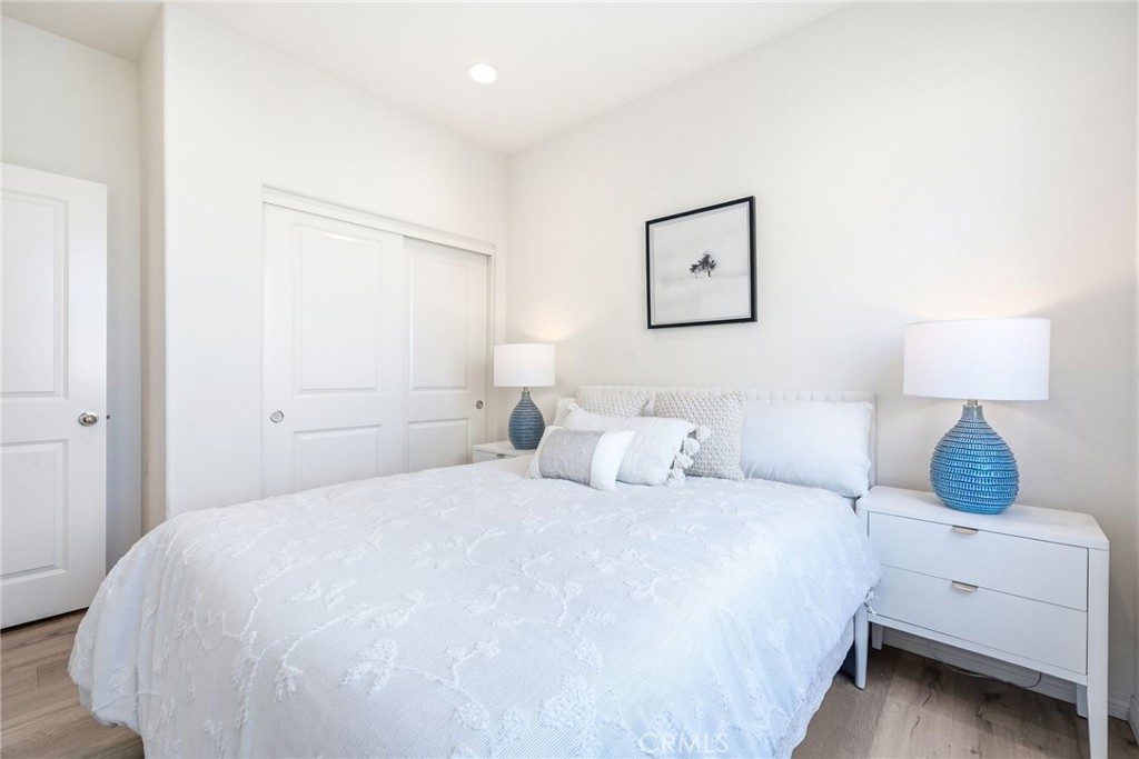 11130 Legion Loop, Unit 105 El Monte, CA 91731 - Photo 16 of 49 a bedroom with a bed and a lamp