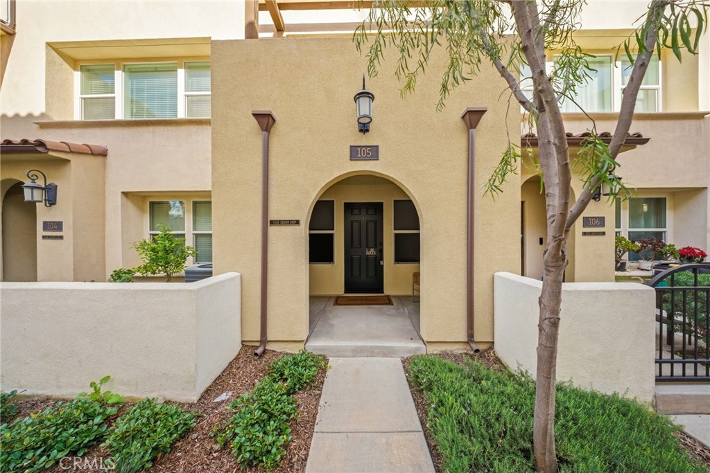 11130 Legion Loop, Unit 105 El Monte, CA 91731 - Photo 2 of 49 a front view of a house with a garden
