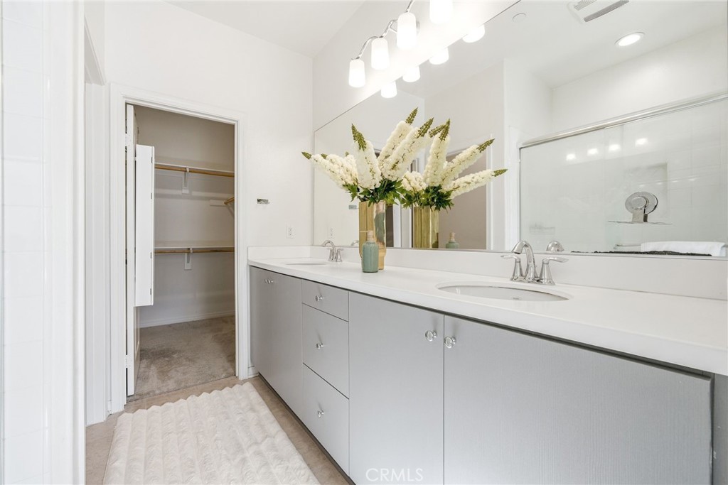 11130 Legion Loop, Unit 105 El Monte, CA 91731 - Photo 23 of 49 a bathroom with a double vanity sink and a mirror