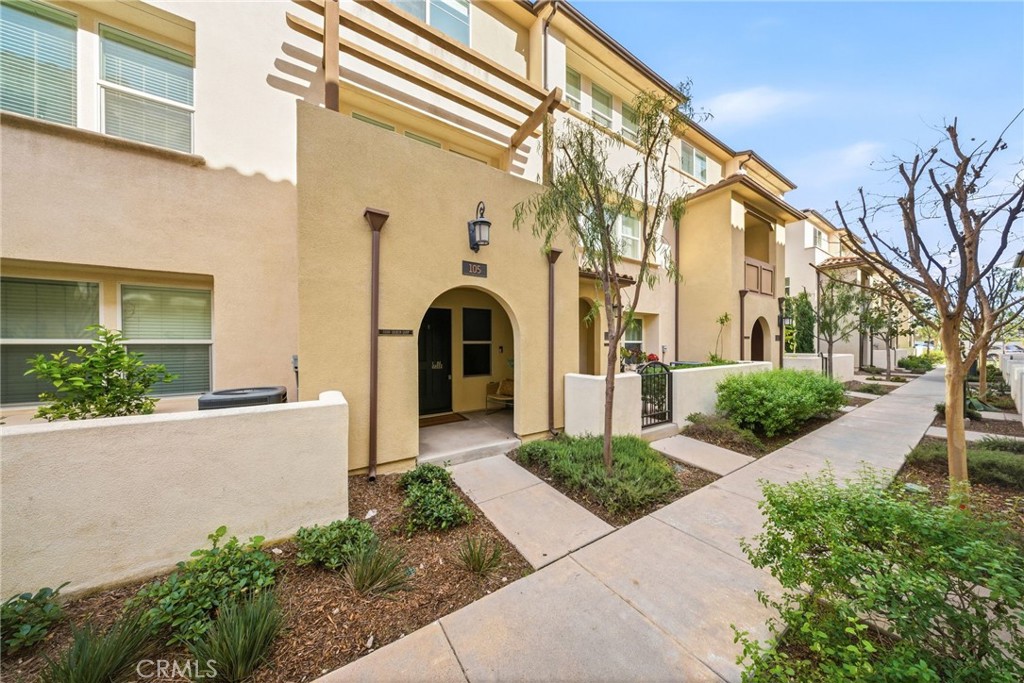 11130 Legion Loop, Unit 105 El Monte, CA 91731 - Photo 33 of 49 a view of a white house with large windows and a small yard
