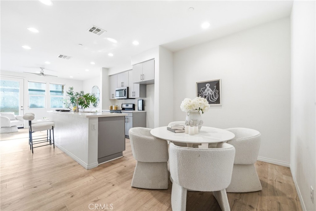 11130 Legion Loop, Unit 105 El Monte, CA 91731 - Photo 5 of 49 a dining room with furniture and wooden floor